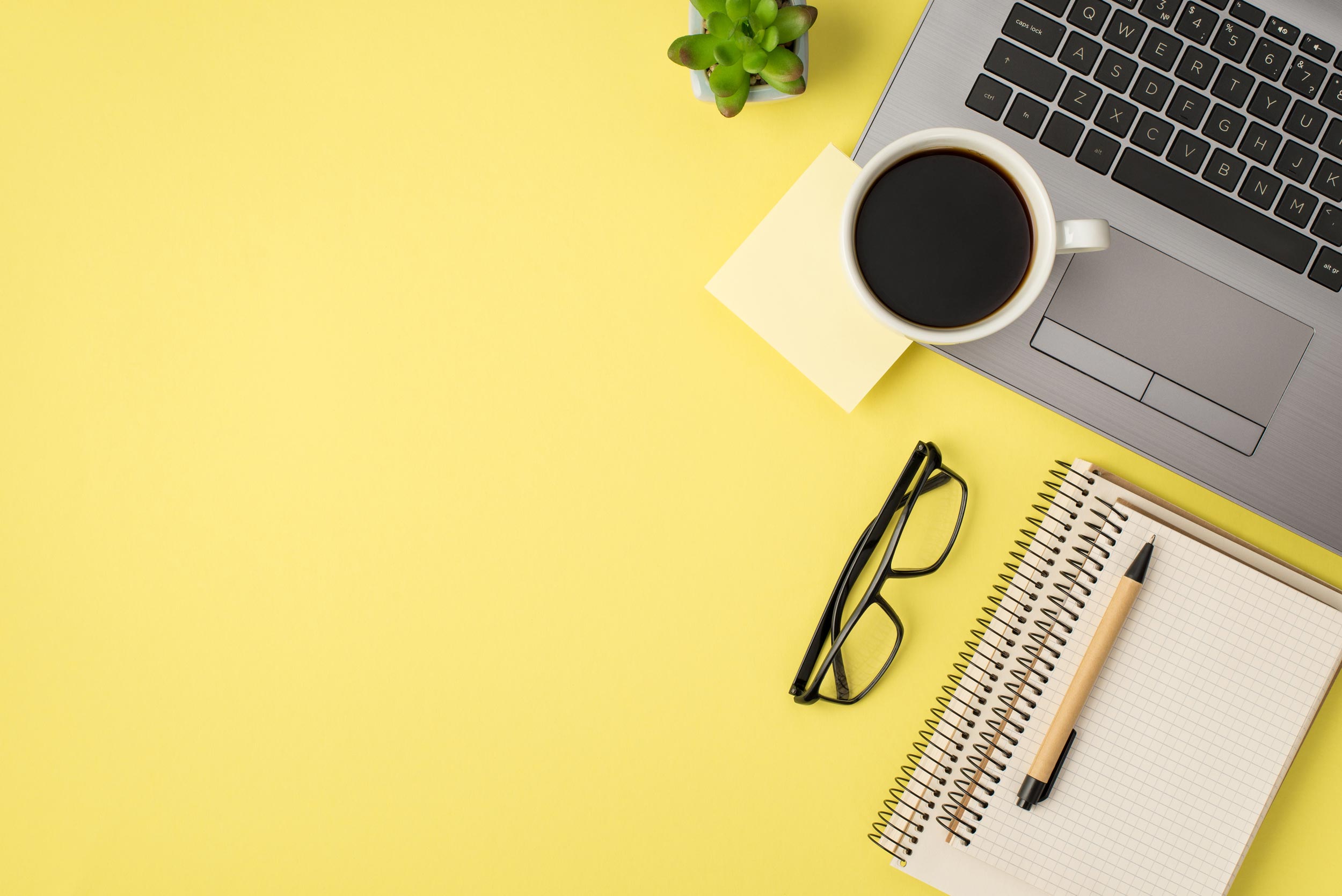Office desk flat lay with coffee and glasses