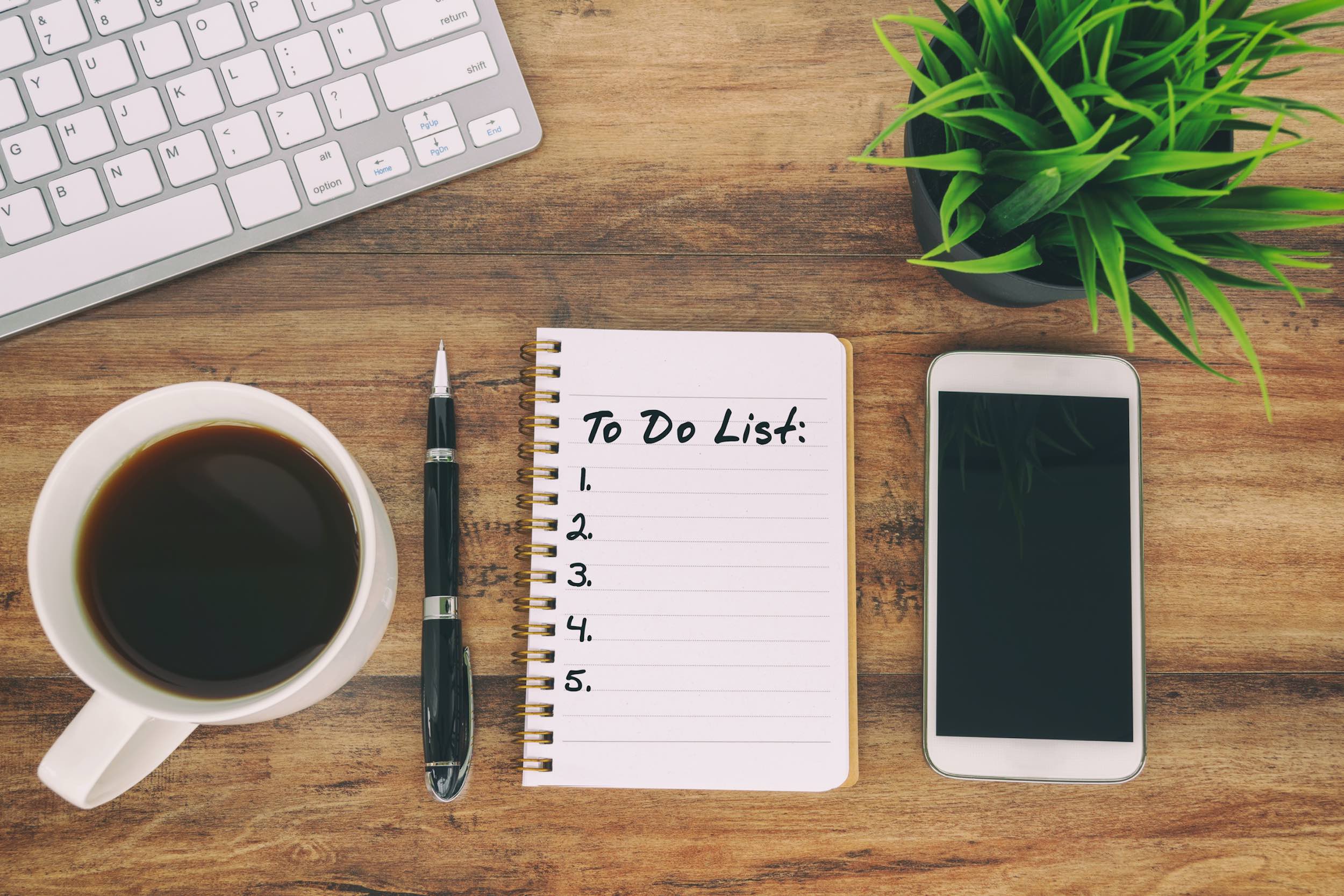 Aerial view of a to-do list, notepad, and coffee
