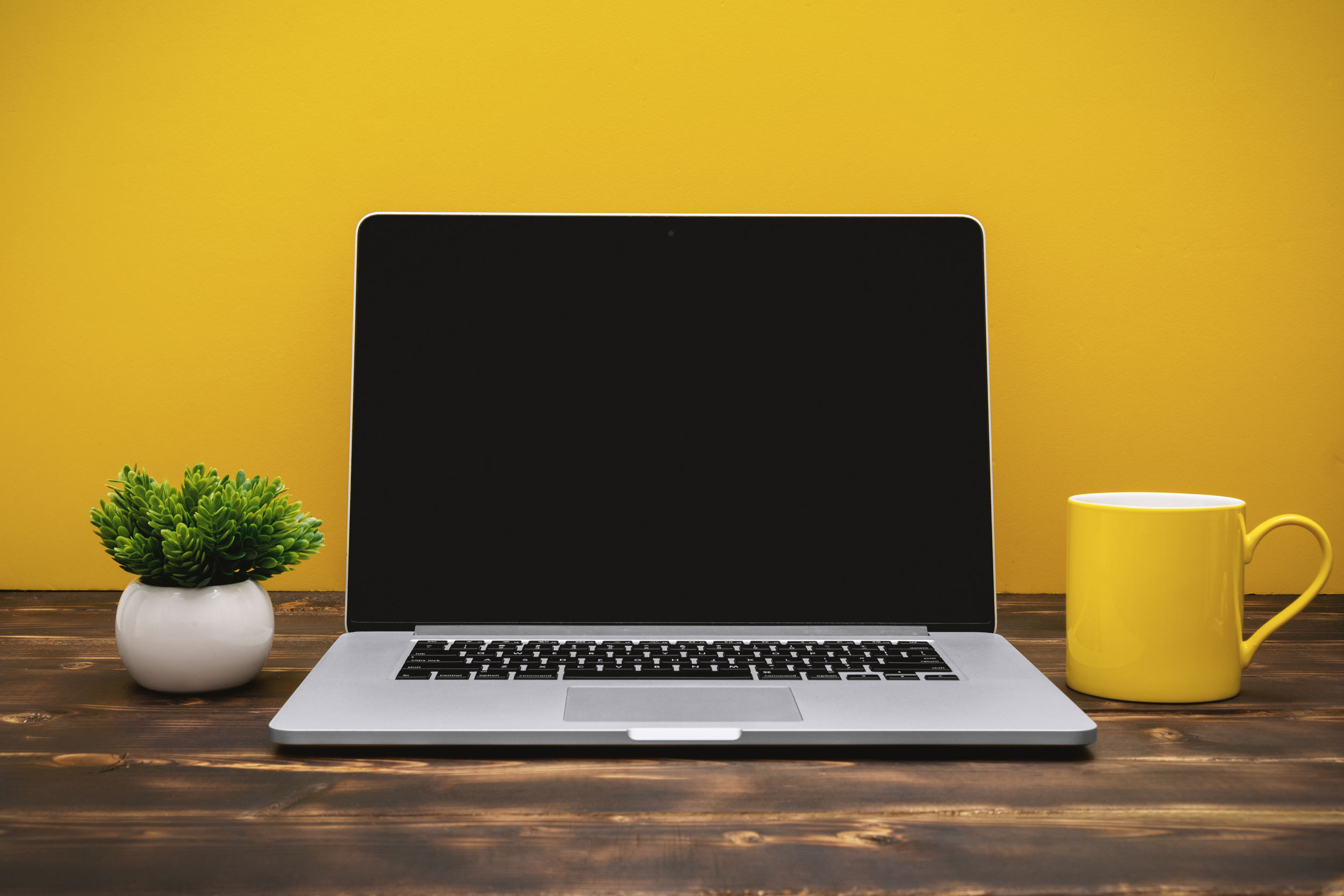 desk table with laptop screen and coffee mug