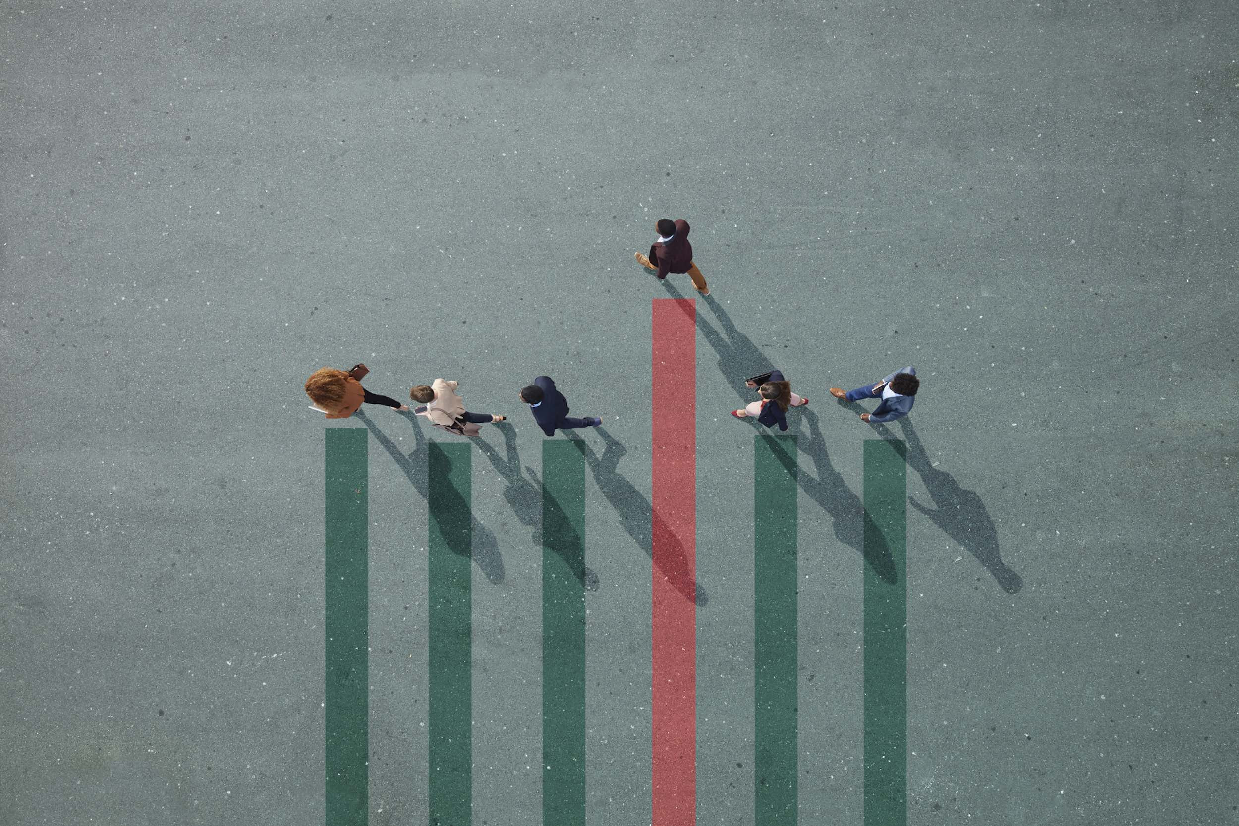 group of people walking on bar chart