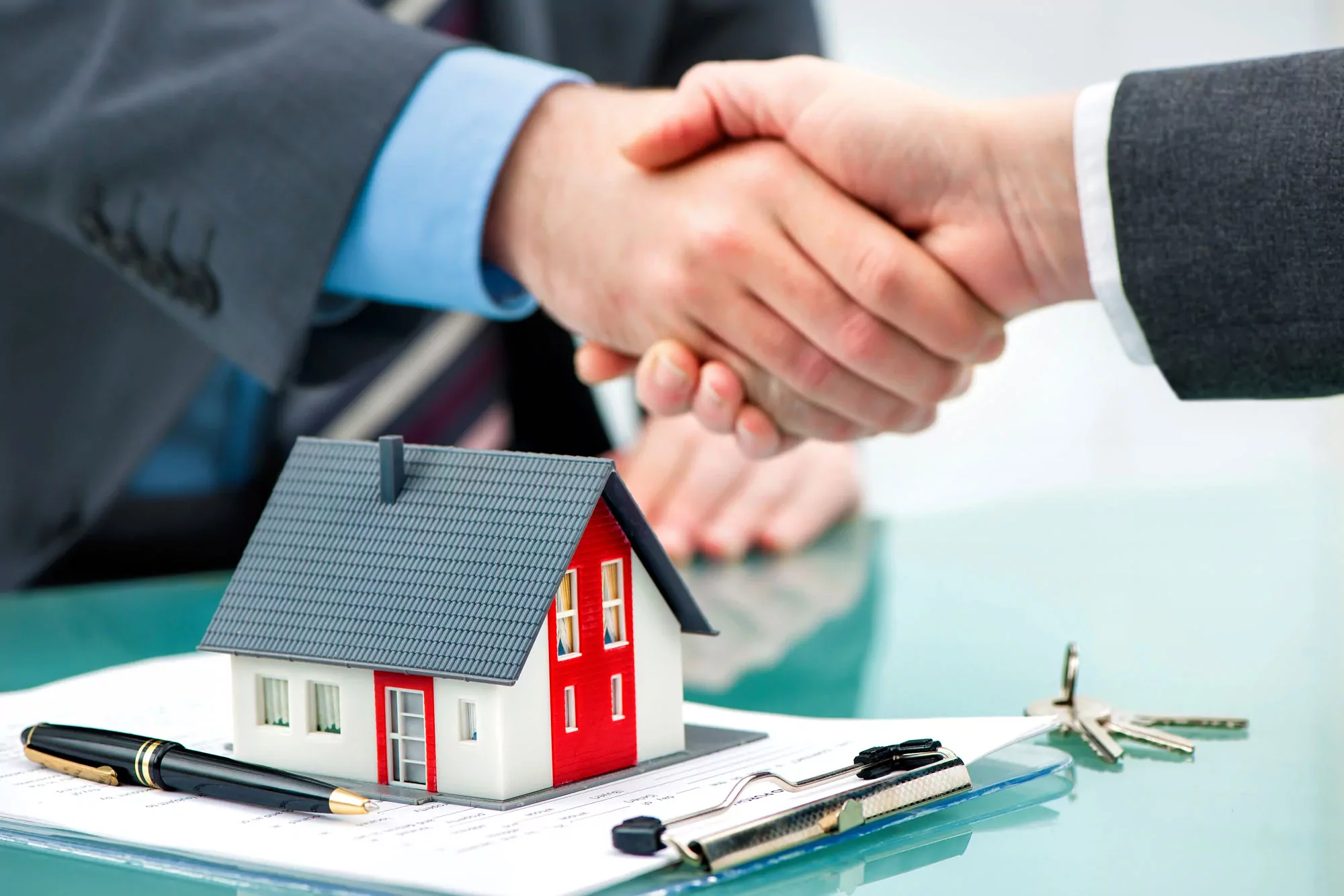 two persons handshakes for the purchasing of home