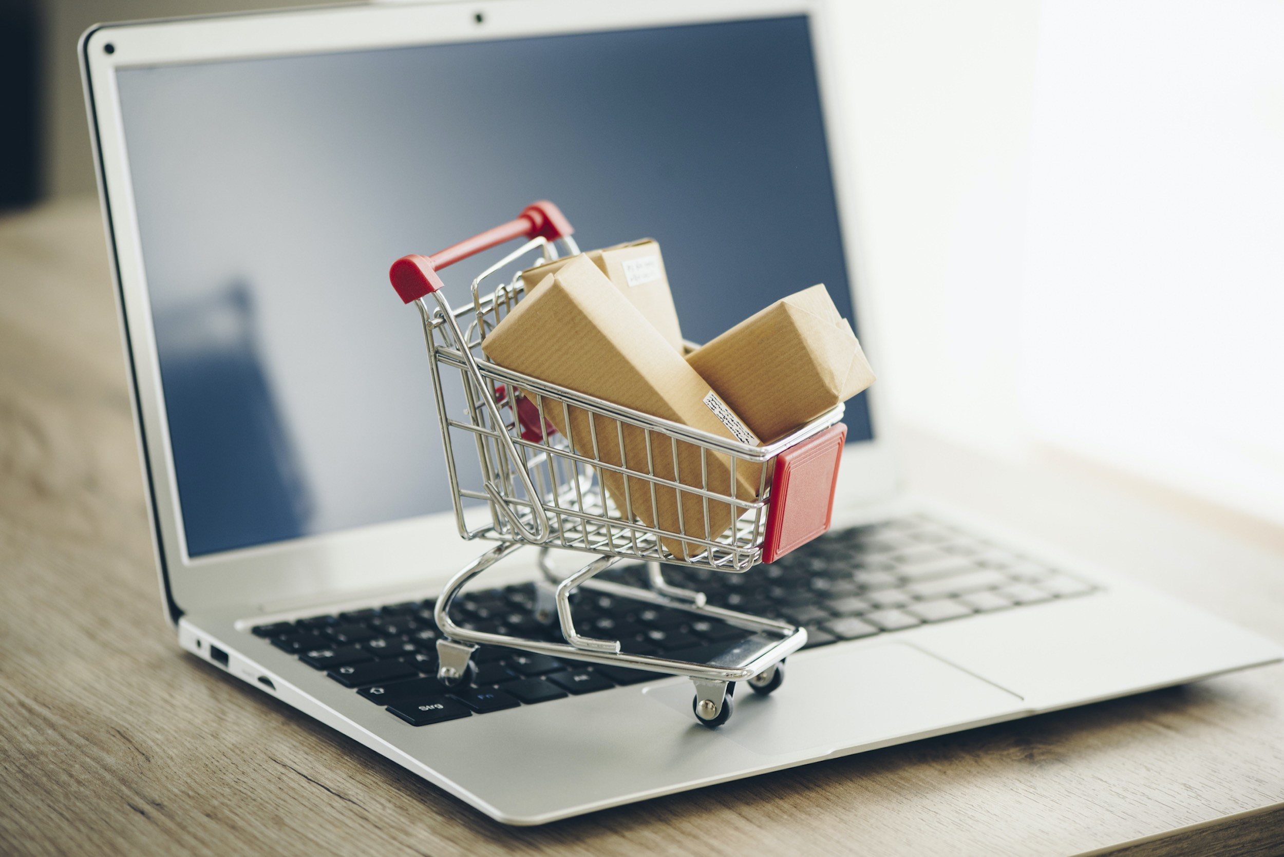 shopping cart on laptop on the top of the table