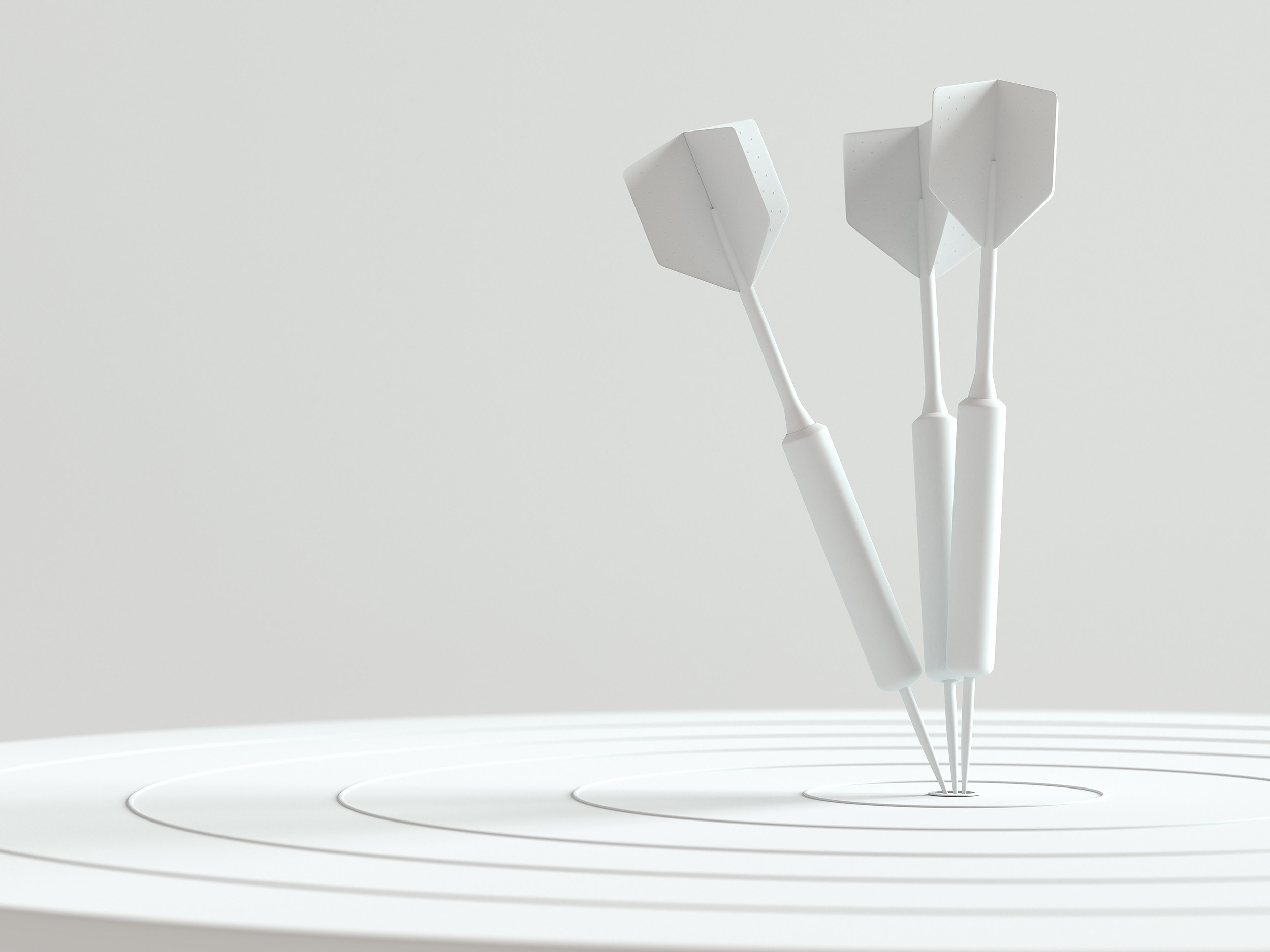 three white color darts targeted in the center point