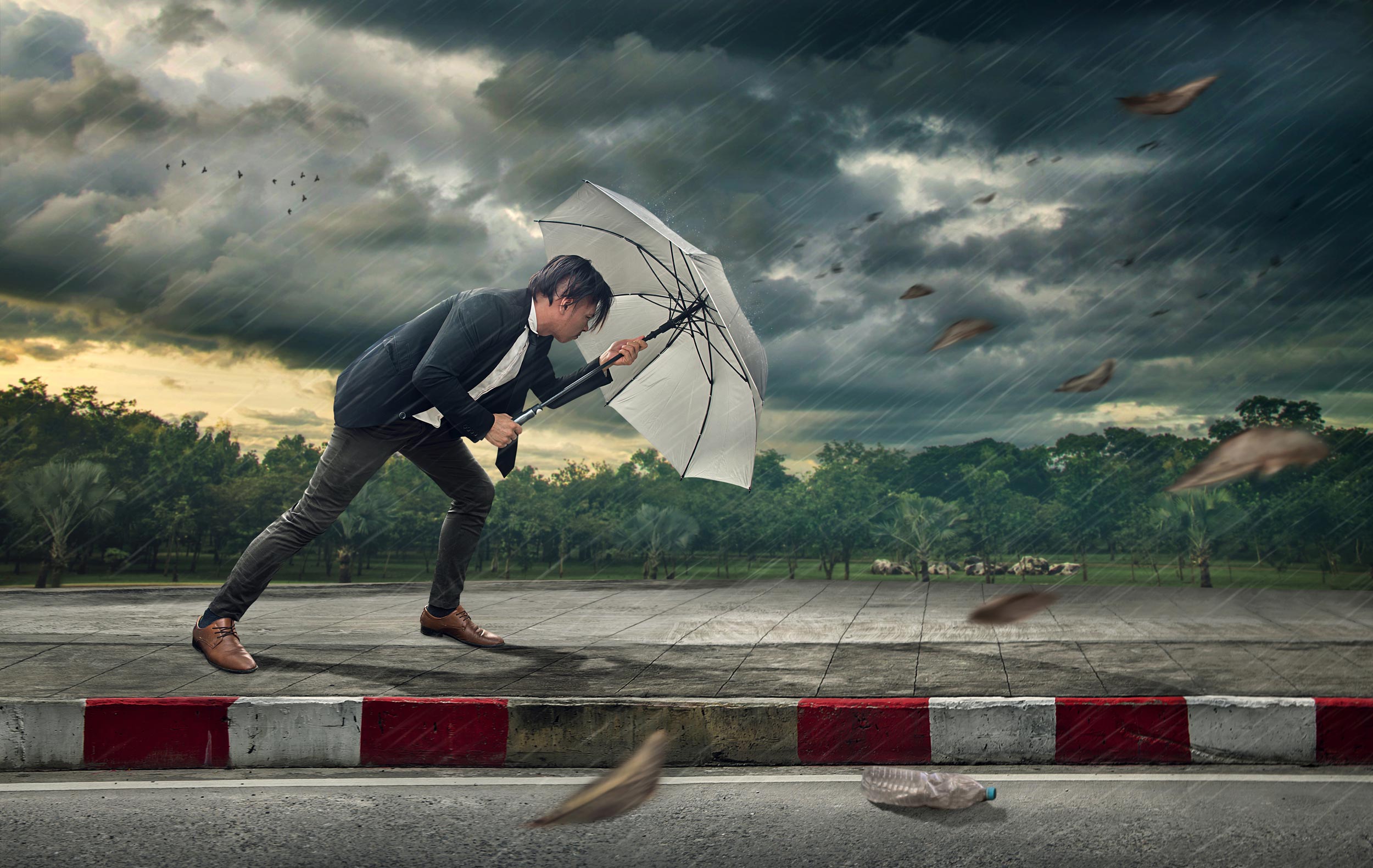 Person facing a difficult financial storm
