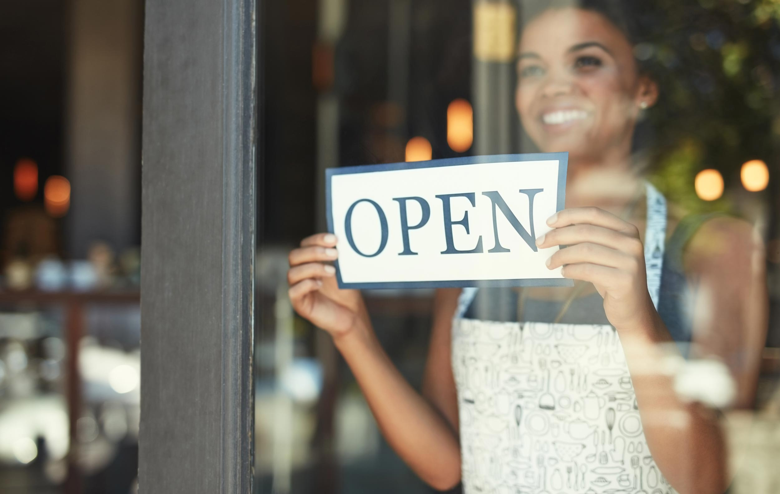 a person with the sign board to start the business