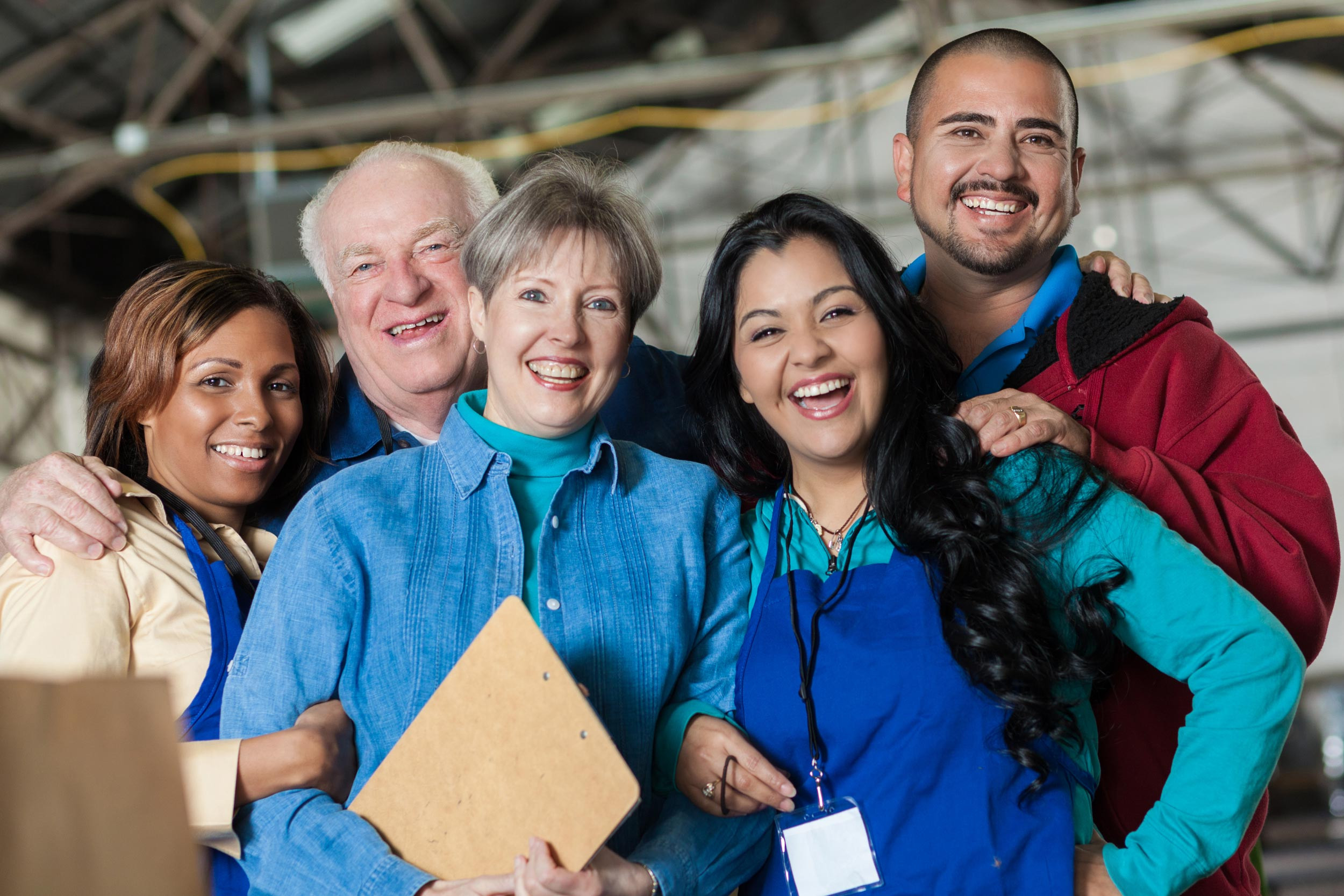 a group of volunteer people smiling with the clipboard