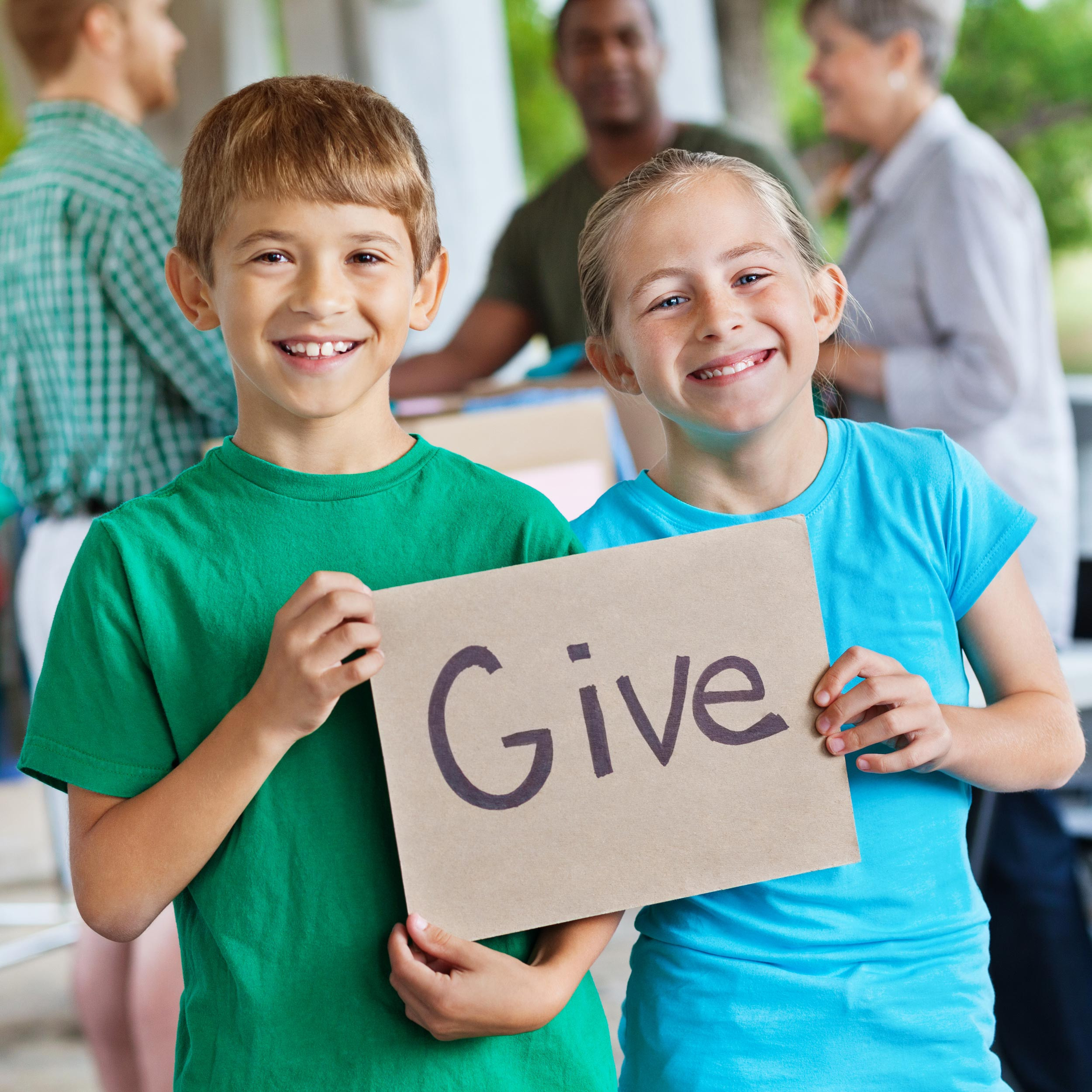 two kids smiling with the give board