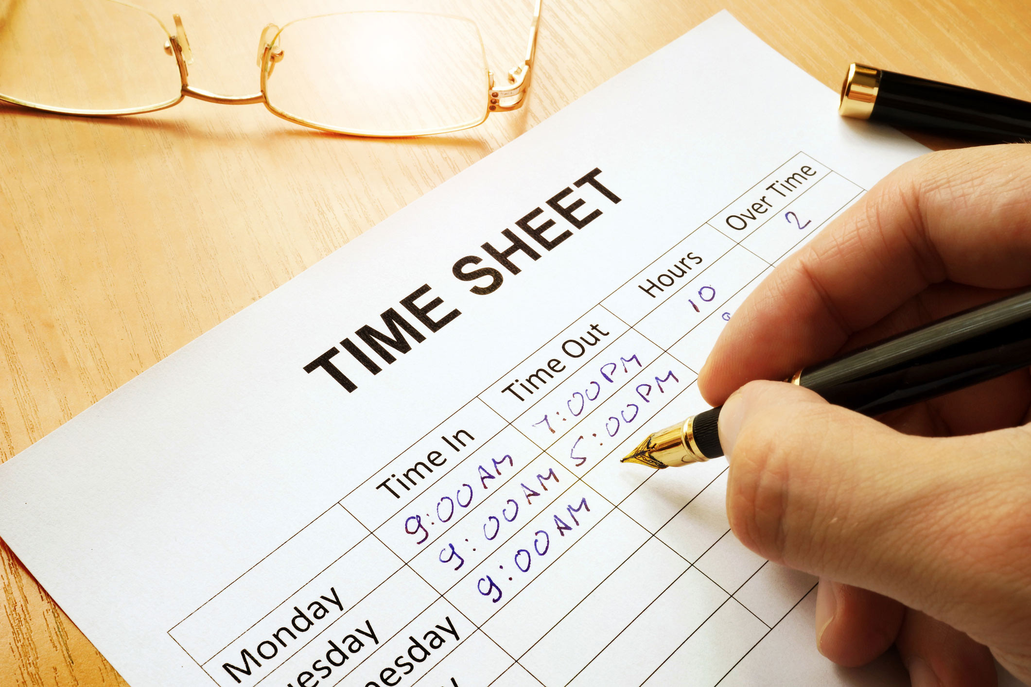 filed timesheet with writing hand