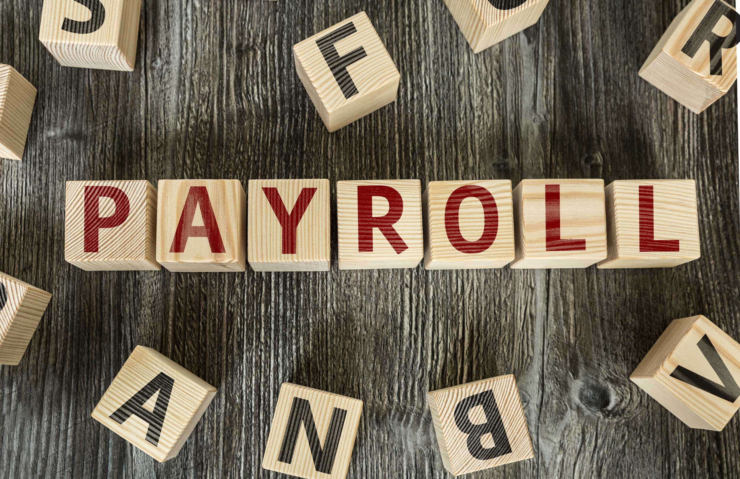 the payroll word formed by wooden blocks