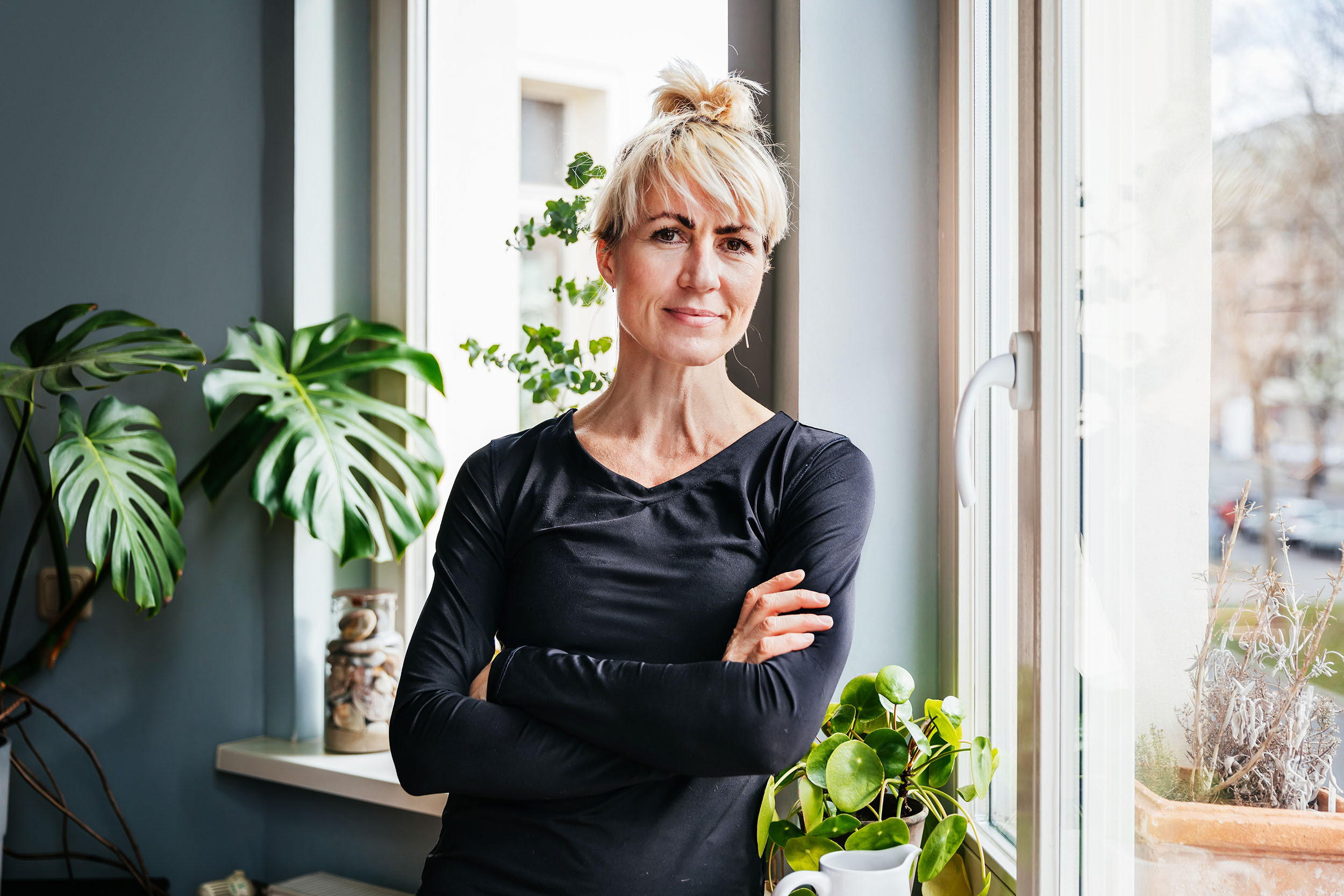 a retired senior professional person standing with cross hands
