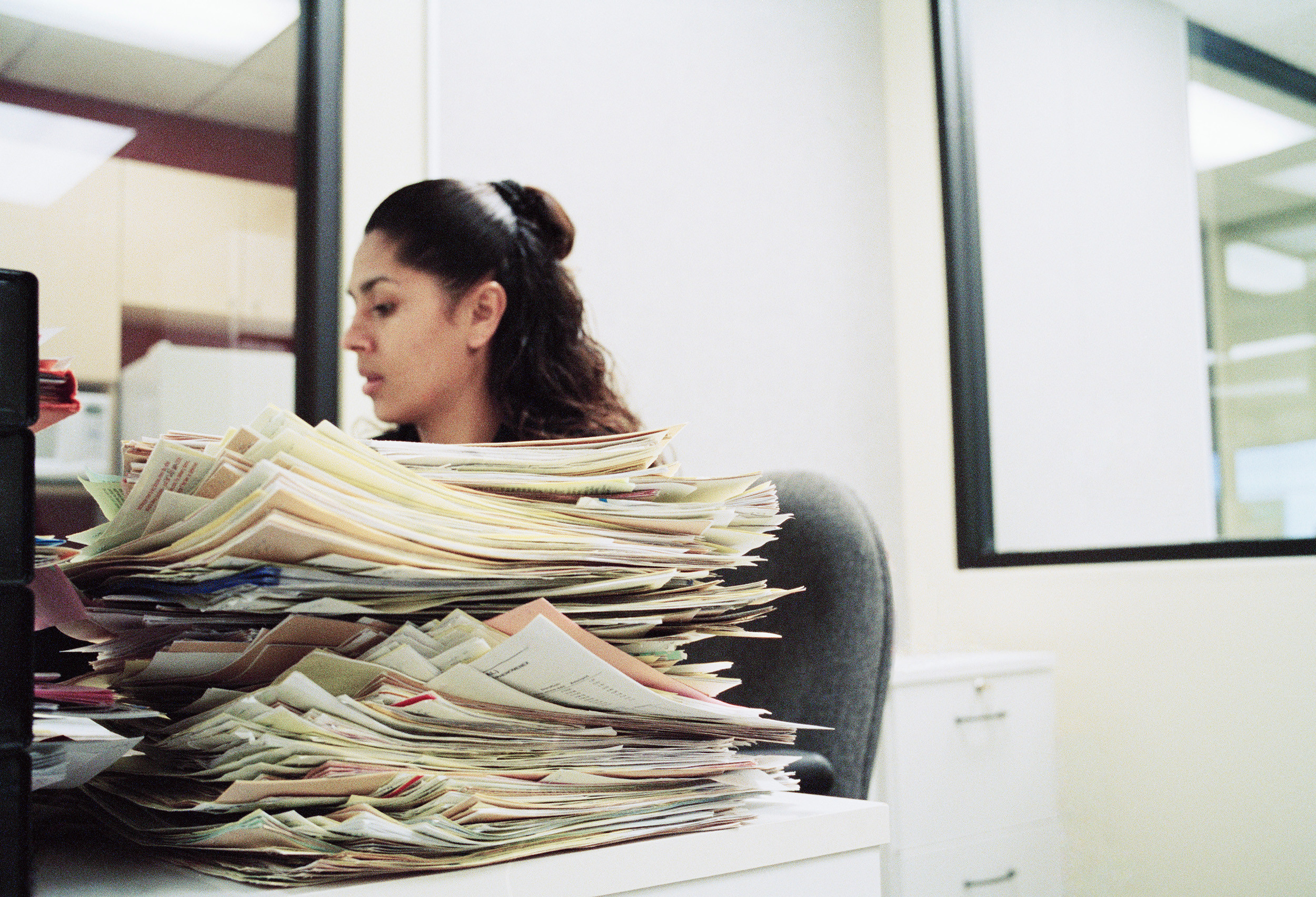 unhappy businessperson at busy paperwork