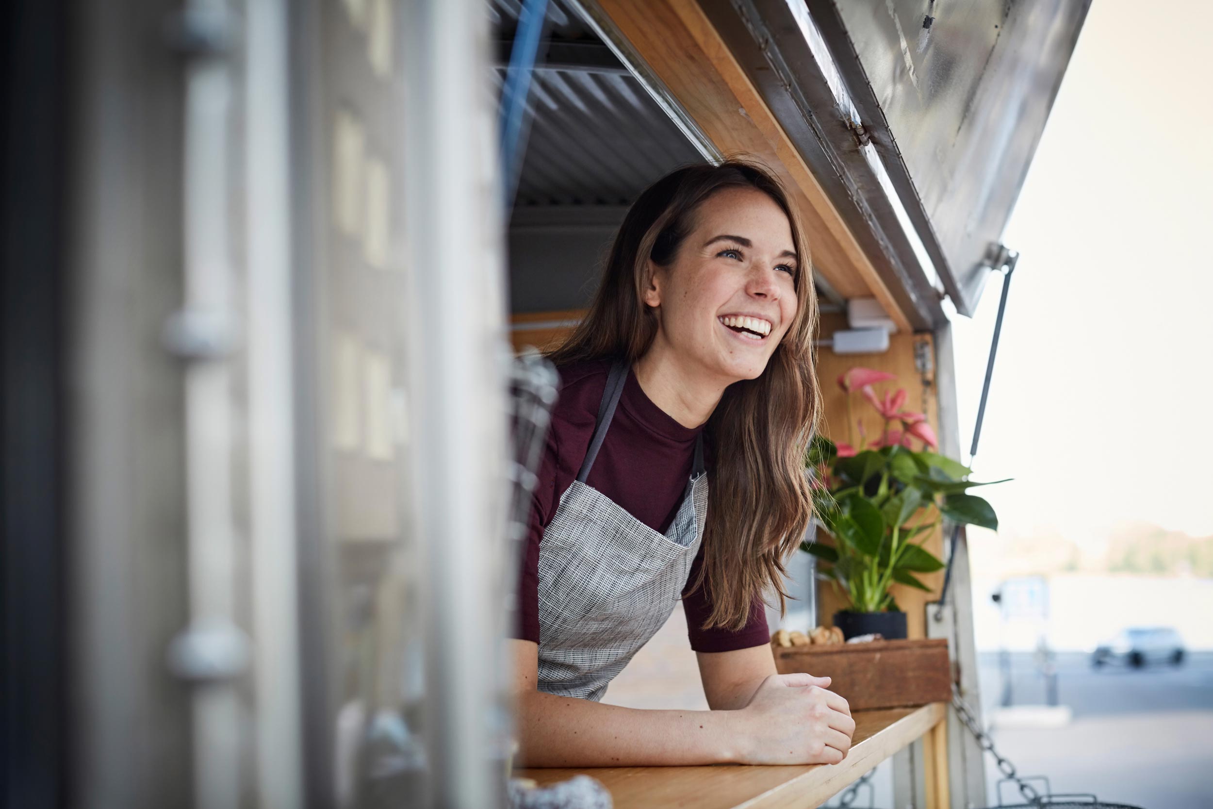 Service worker in food truck handling transactions