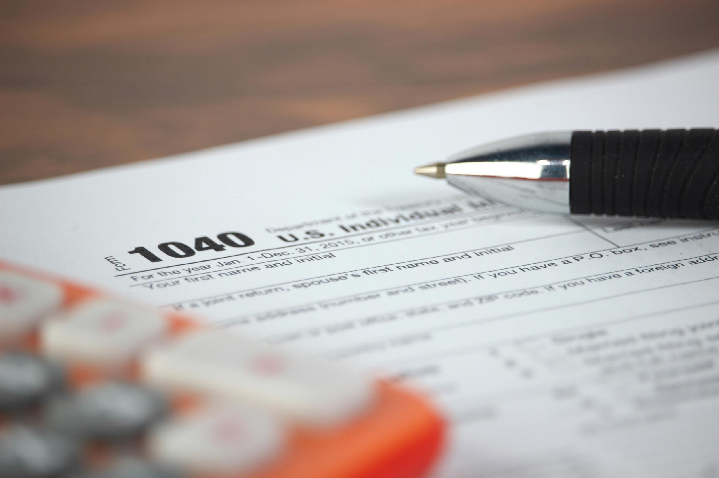 tax form 1040 with calculator and pen