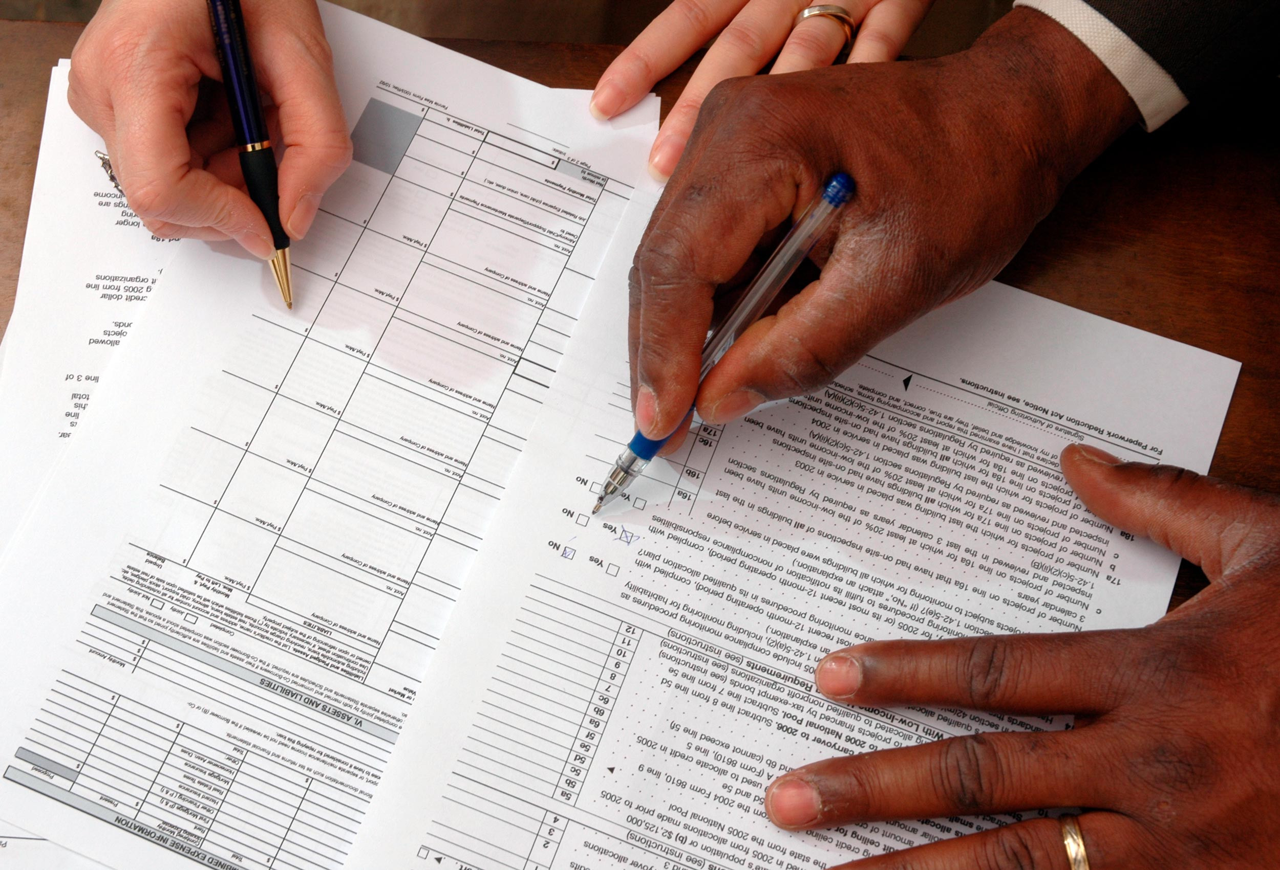 tax form filing by hands with paperwork