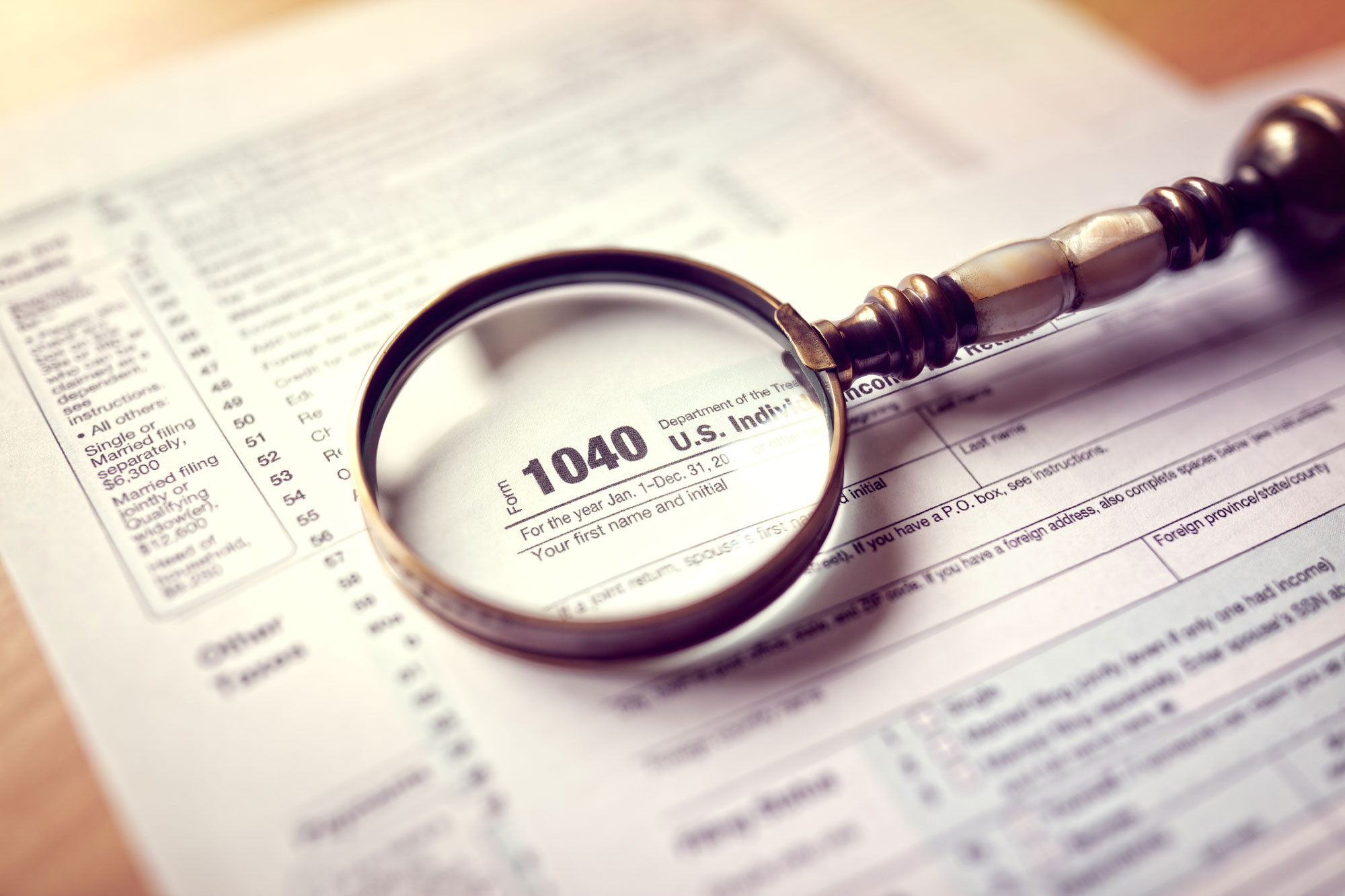 1040 tax form with magnifying glass
