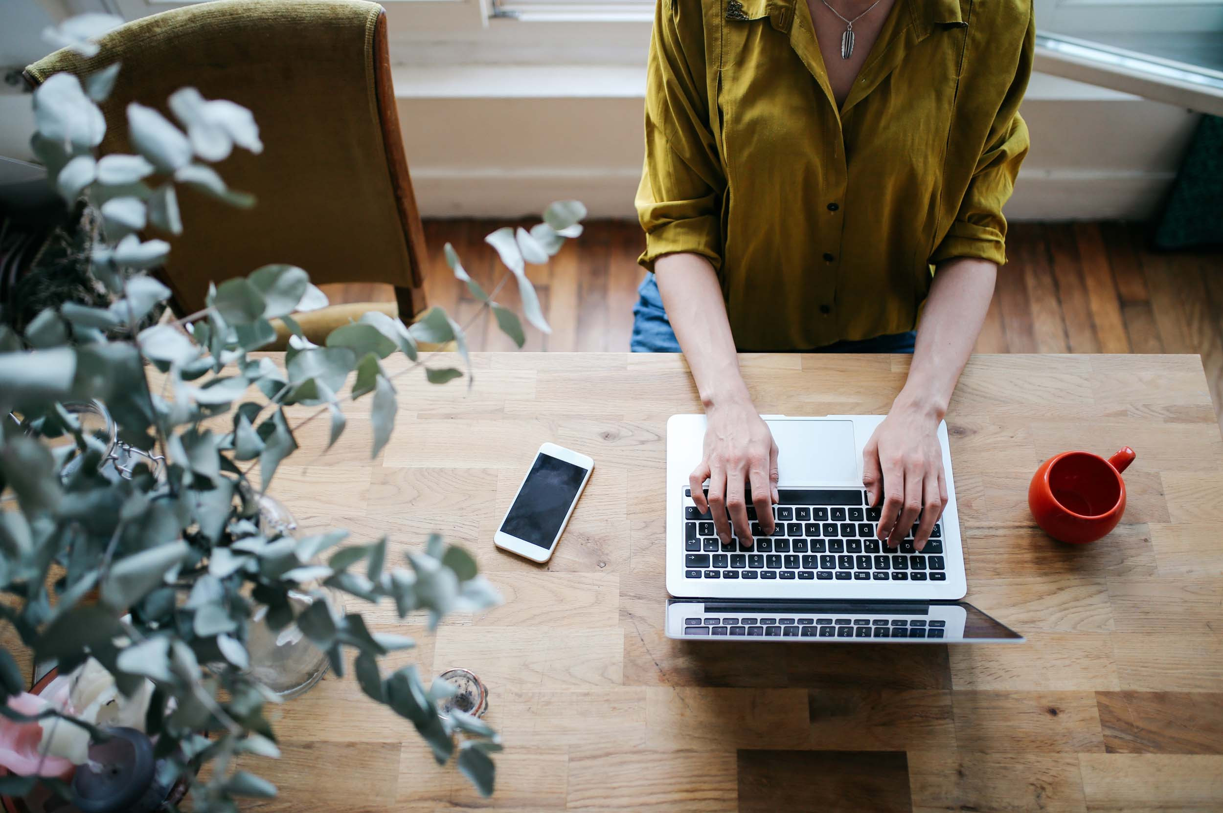 businessperson working in computer with coffee cup and phone