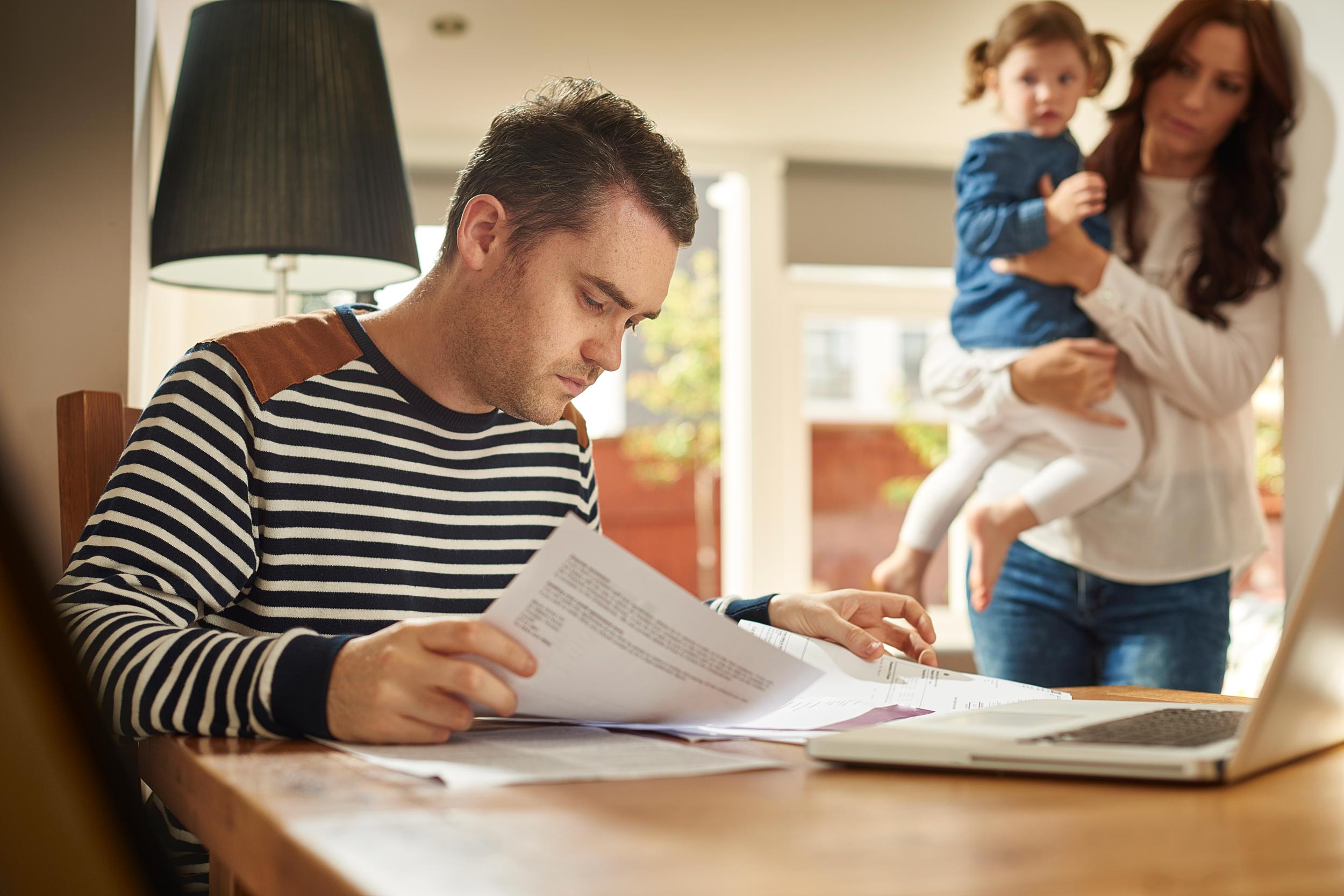 stressed man referring the documents with family
