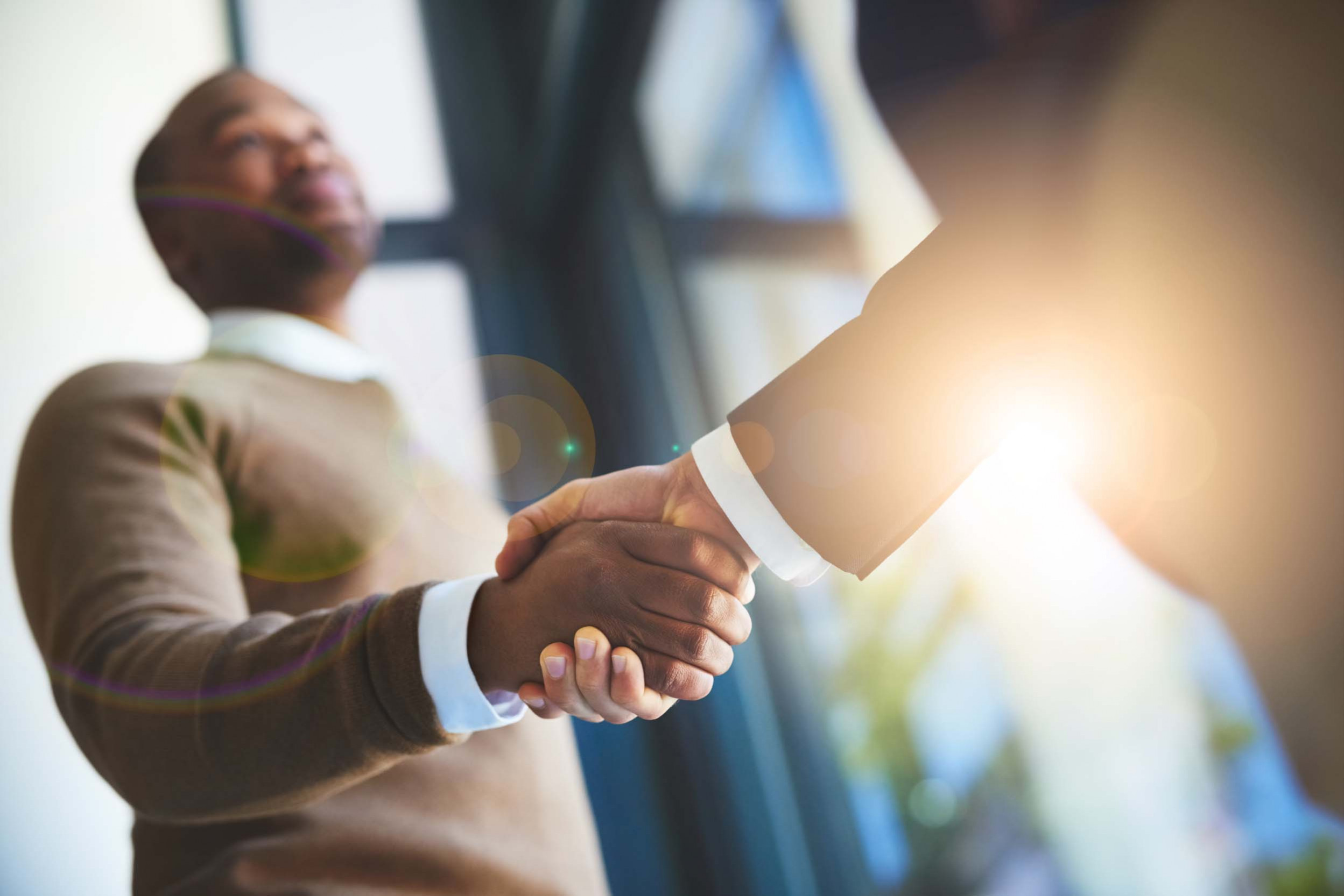 successful business handshake in corporate office