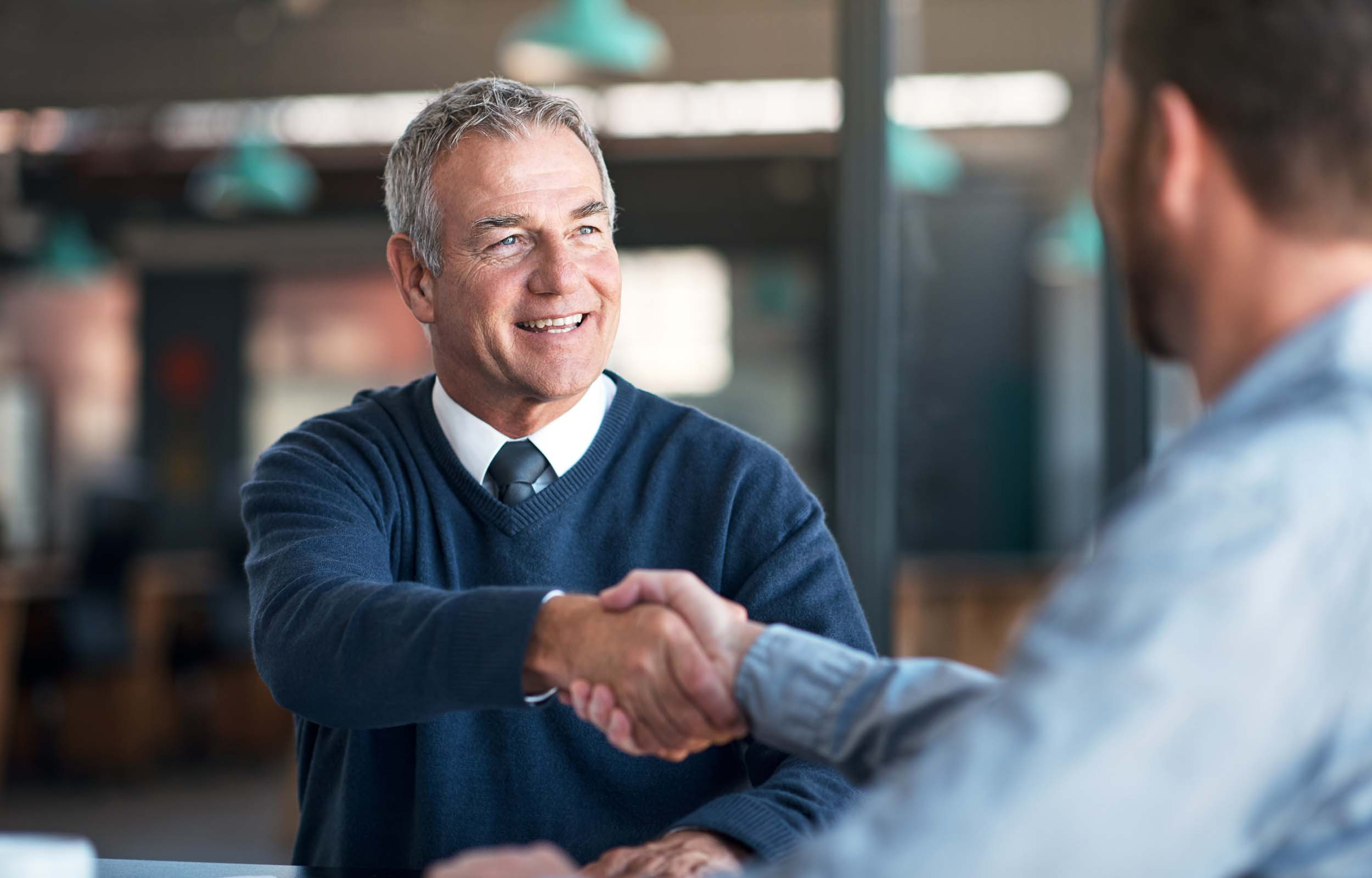 senior business person handshake after successful business meeting