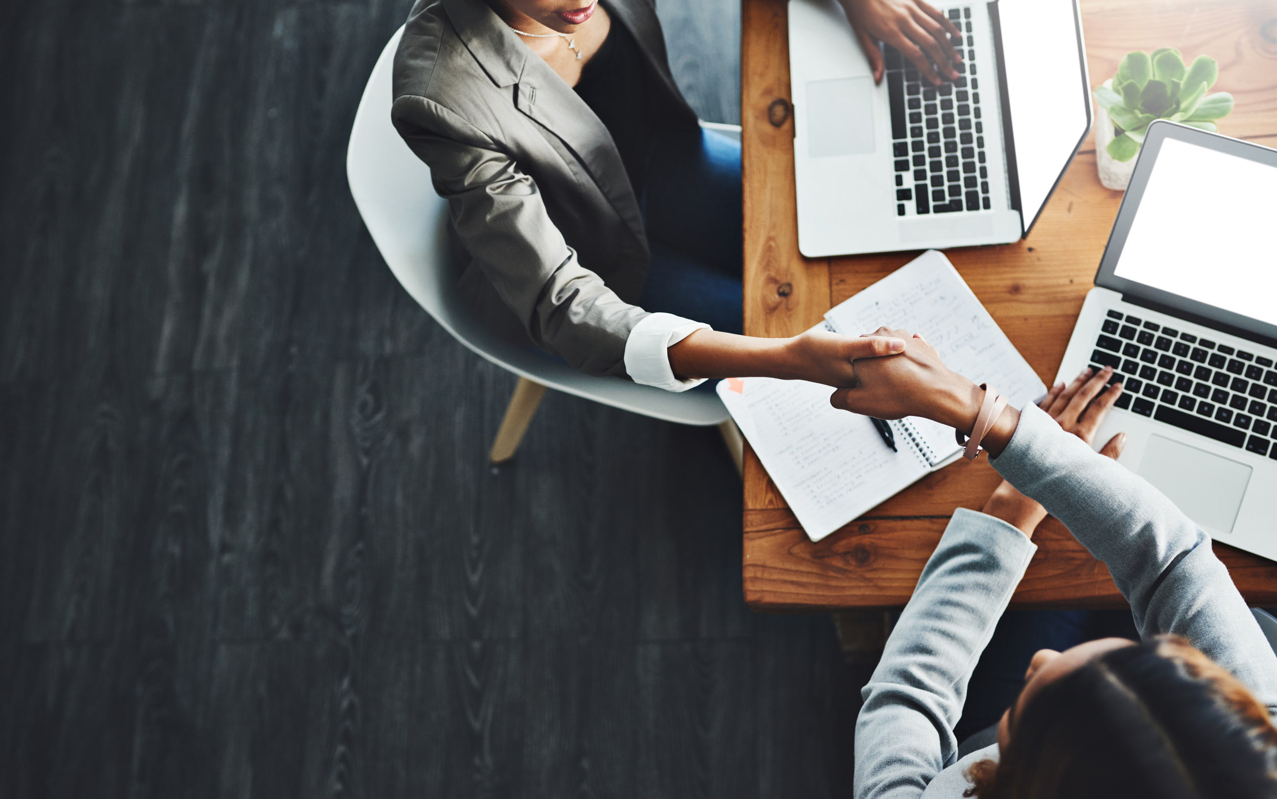 Colleagues shaking hands in a secure office