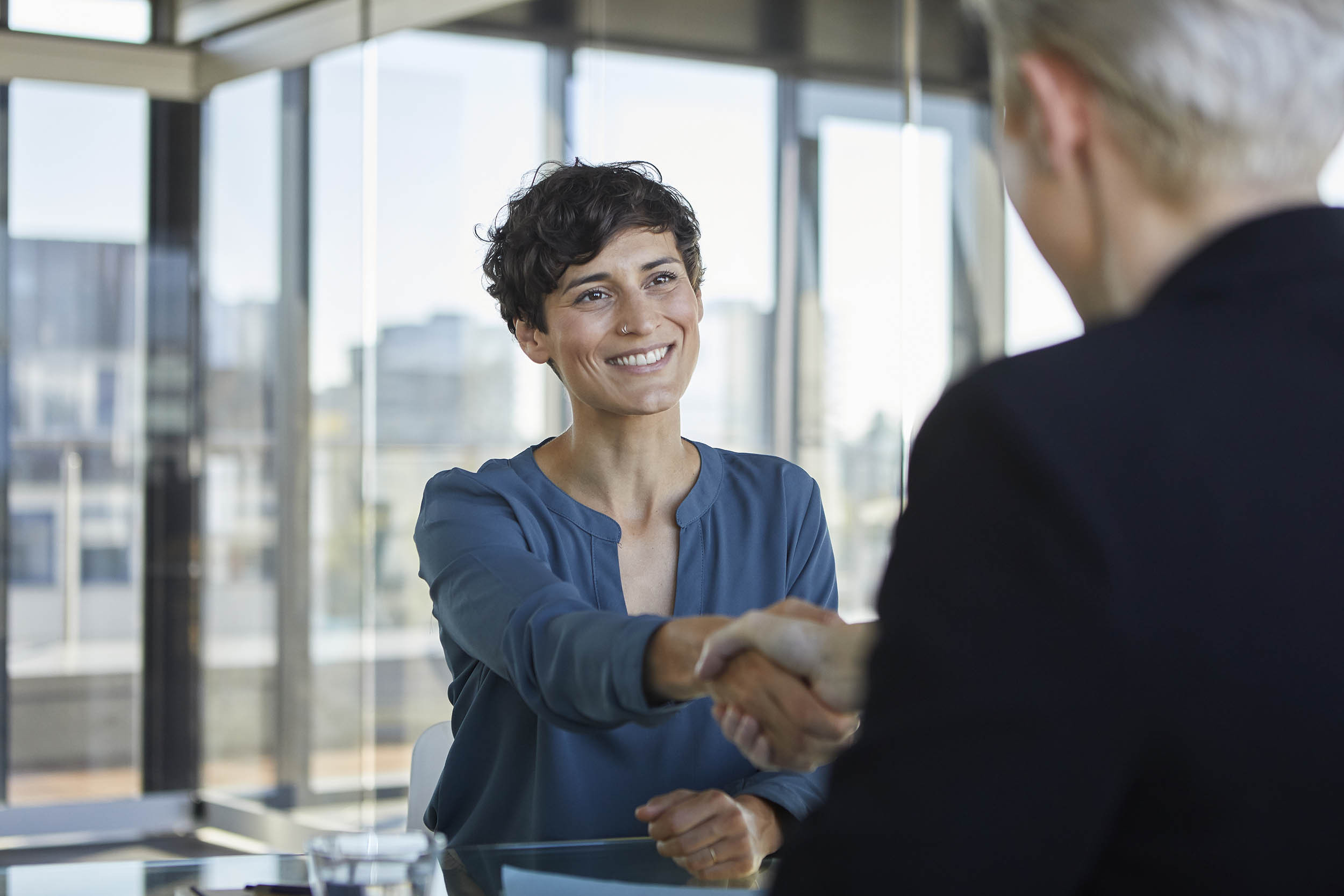 handshake between two persons in consulting meeting
