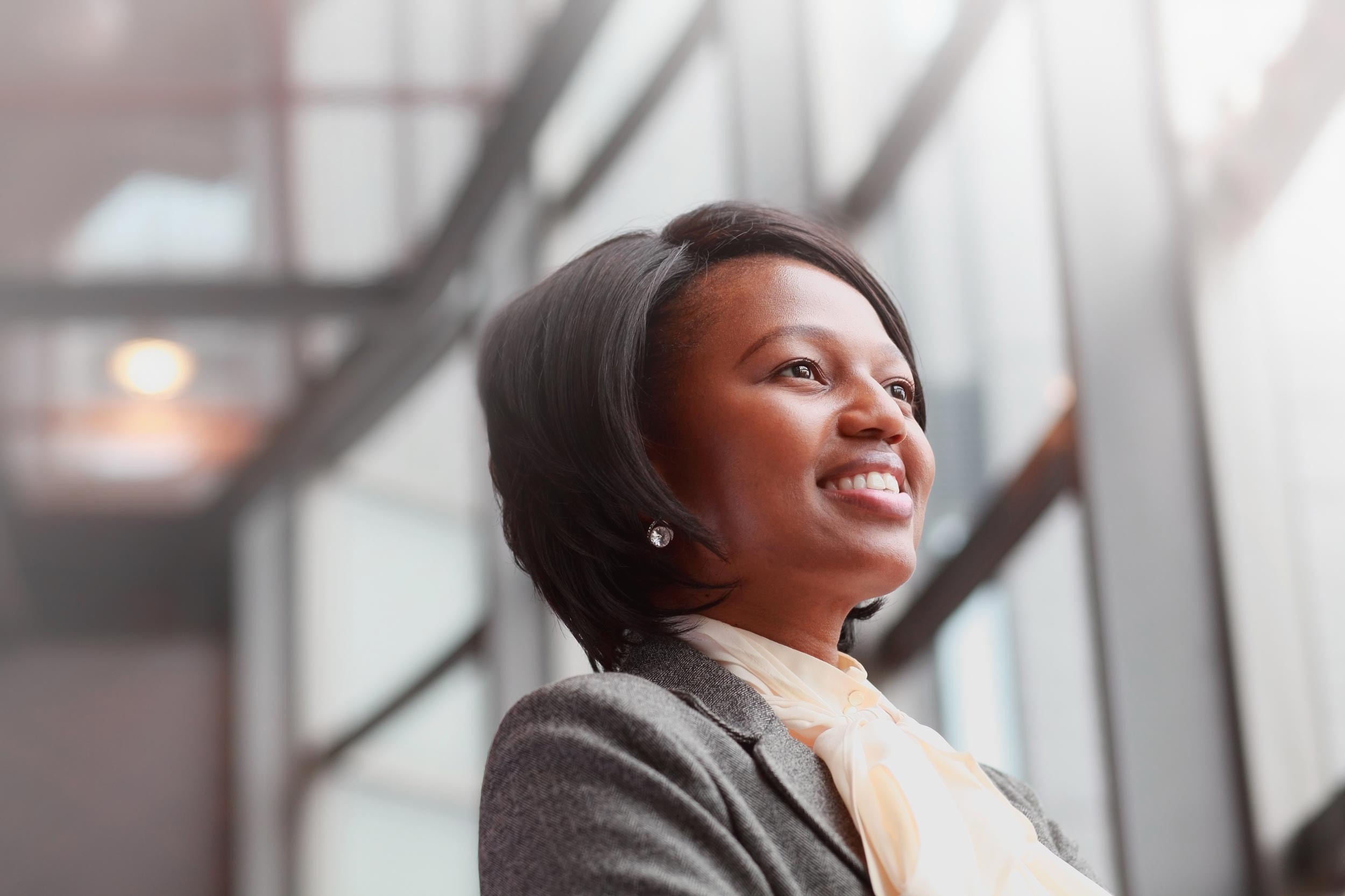 a professional person standing happily near the window