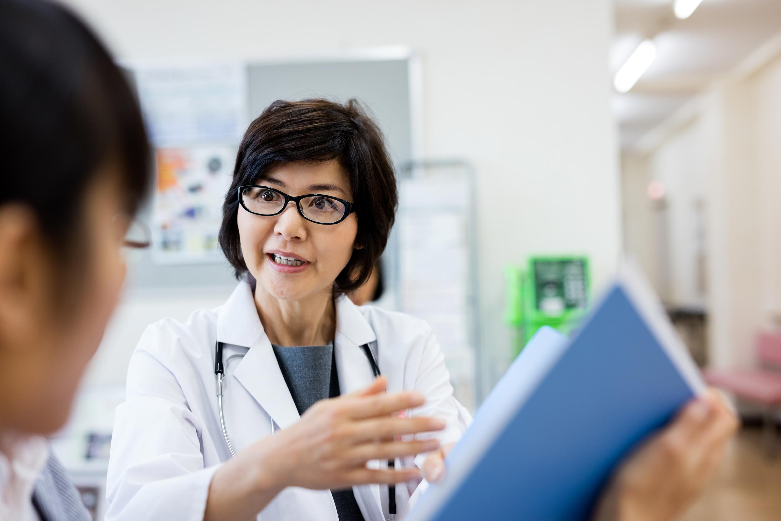 medical professional talking with documents
