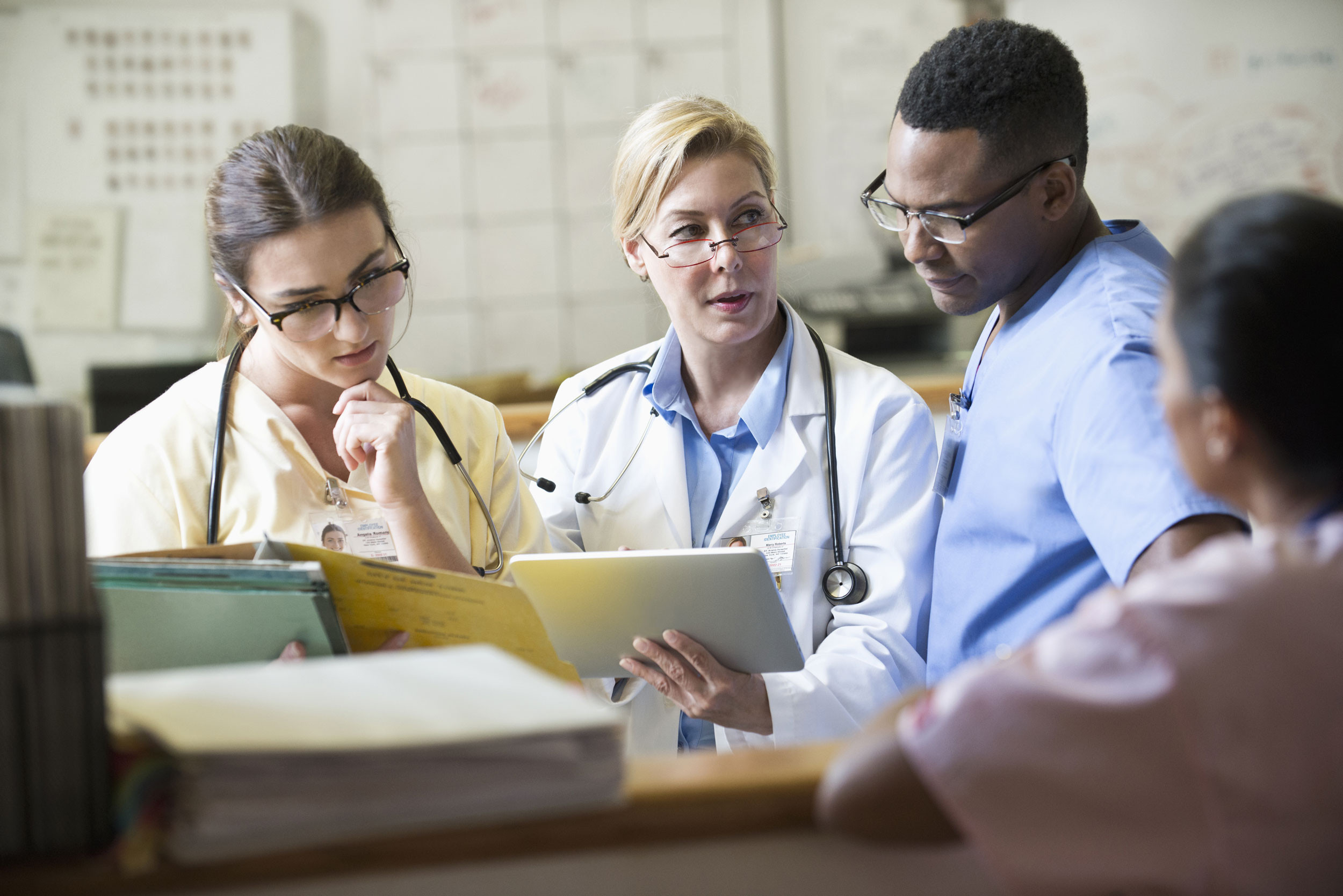 doctor and nurse discussion with tablet at hospital