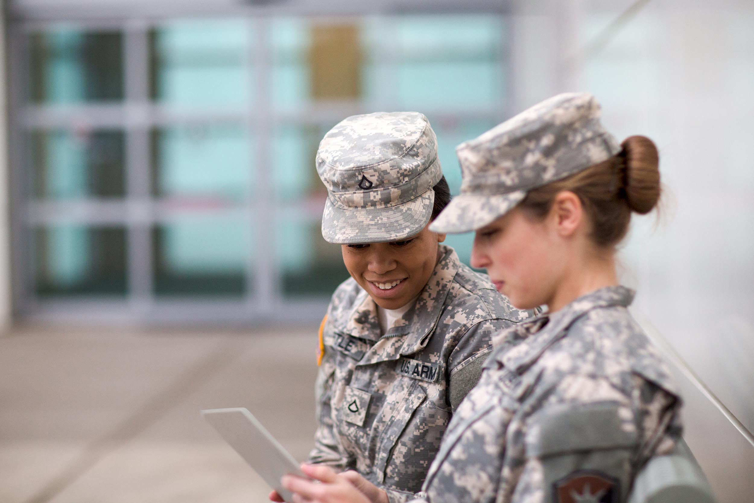 two people military members looking at tablet