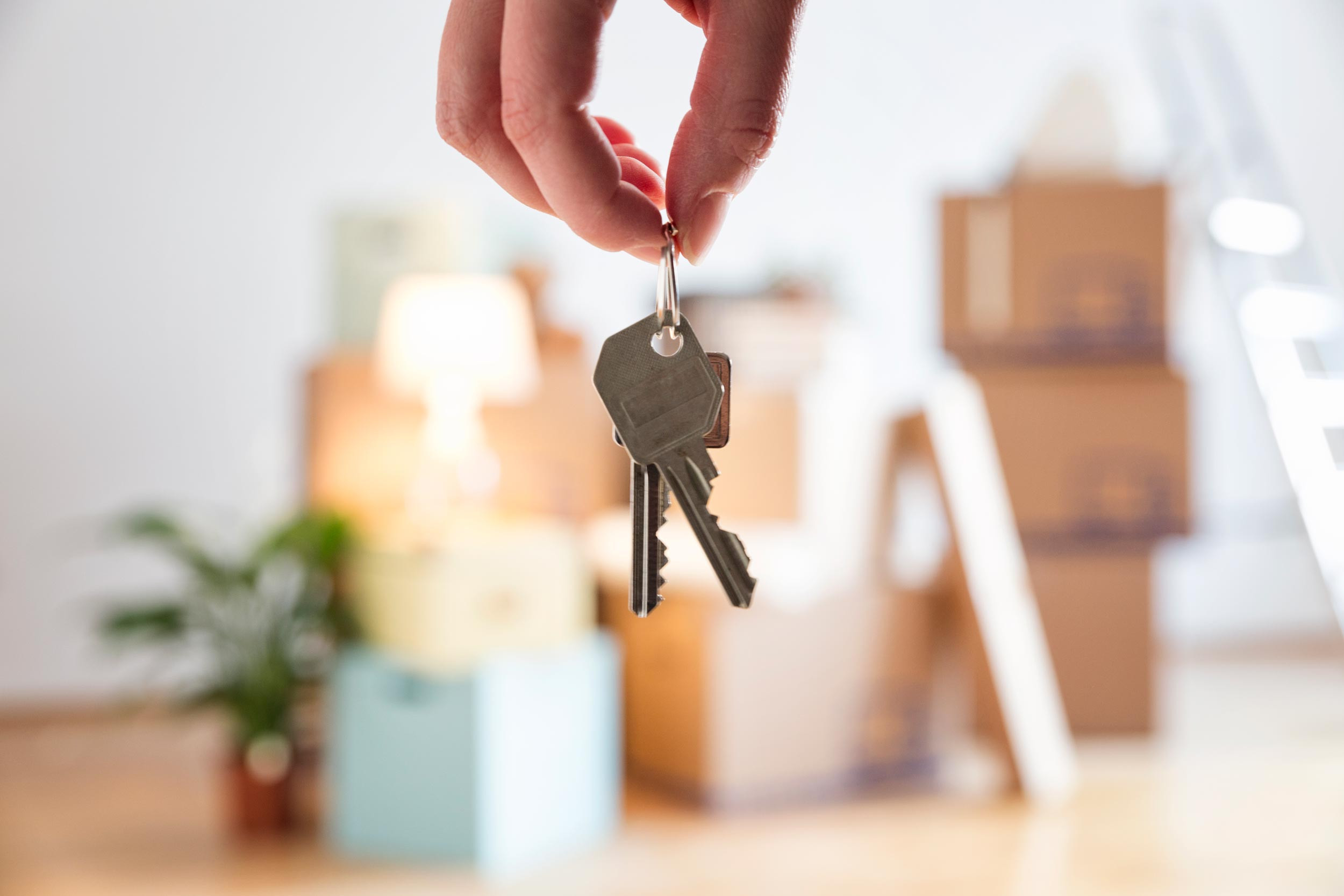 house key in hand at buy a home