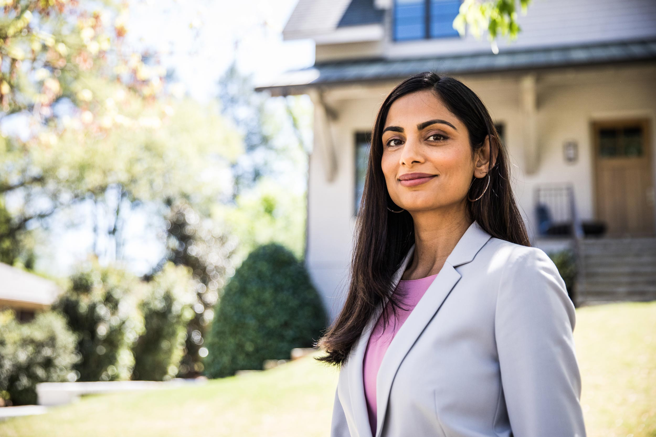 real estate agent standing at house background