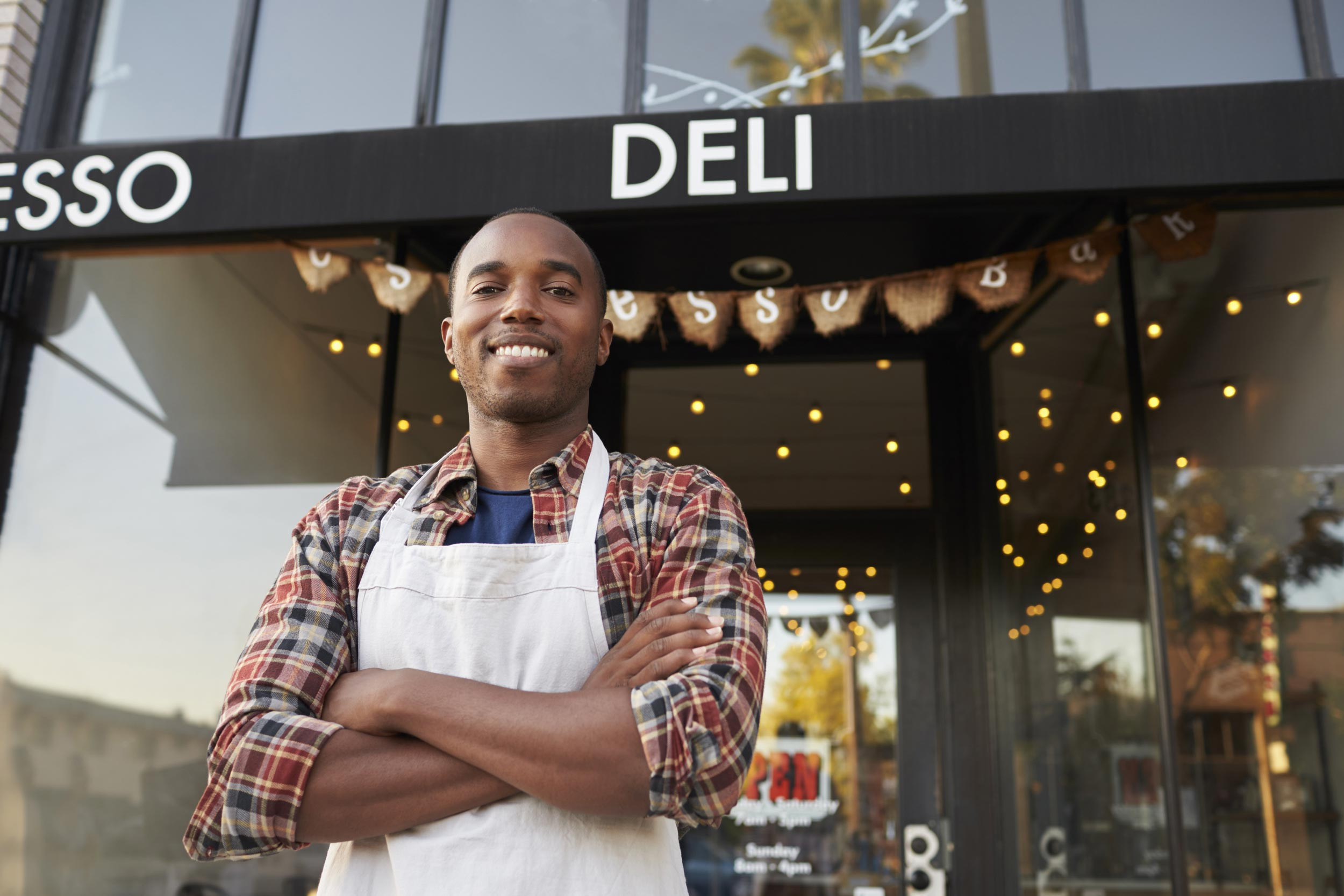 small business owner in front of restaurant cafe