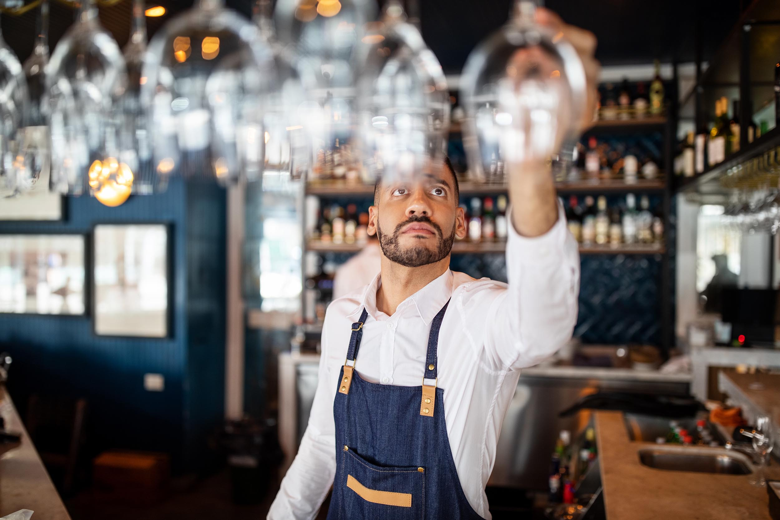 bartender opening shop with glasses