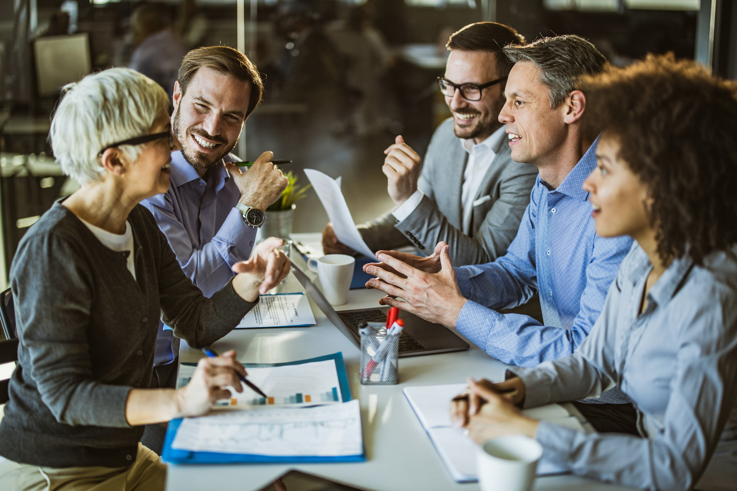 group of people happily discussing in the meeting