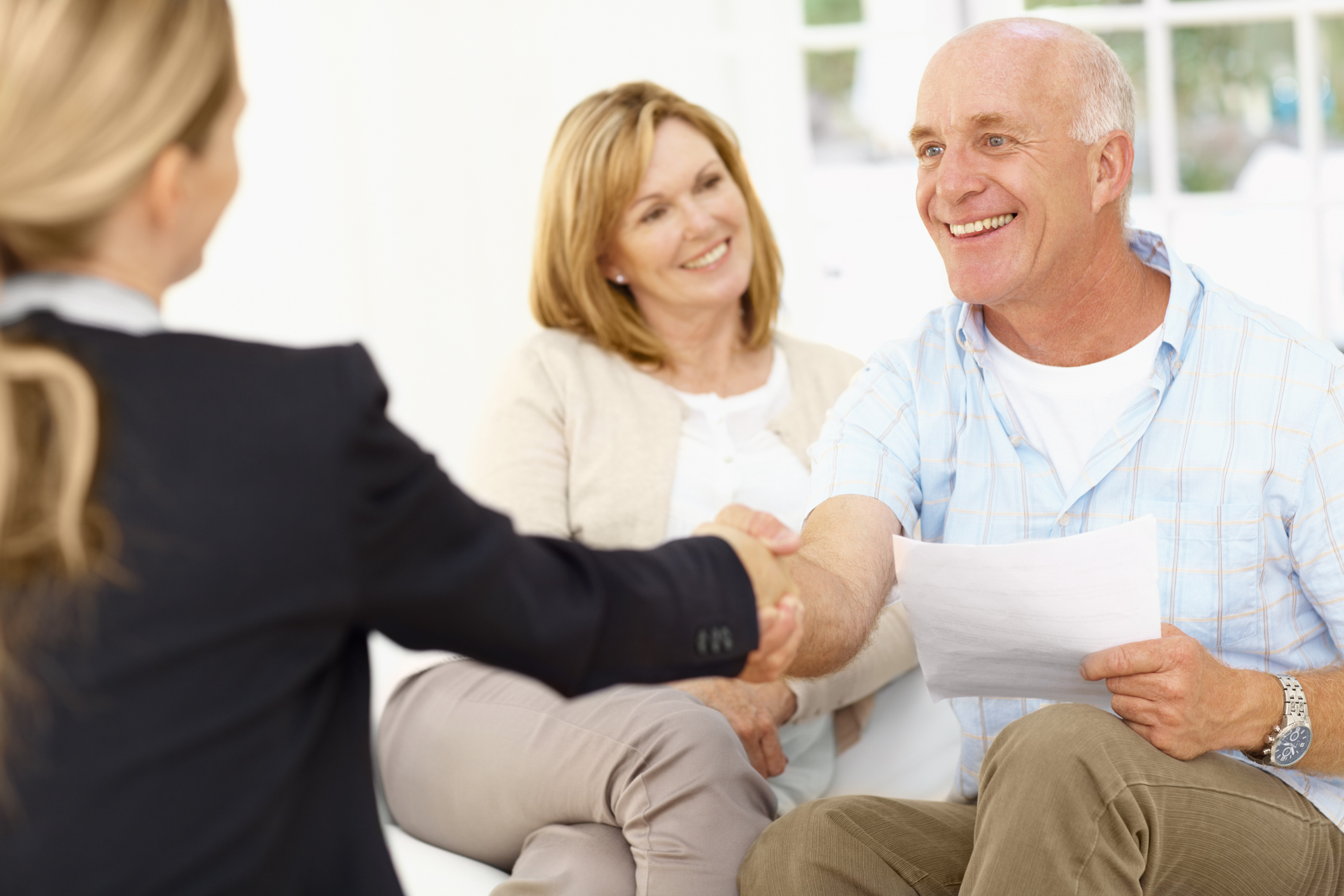 Older couple reviewing tax documents with a financial advisor