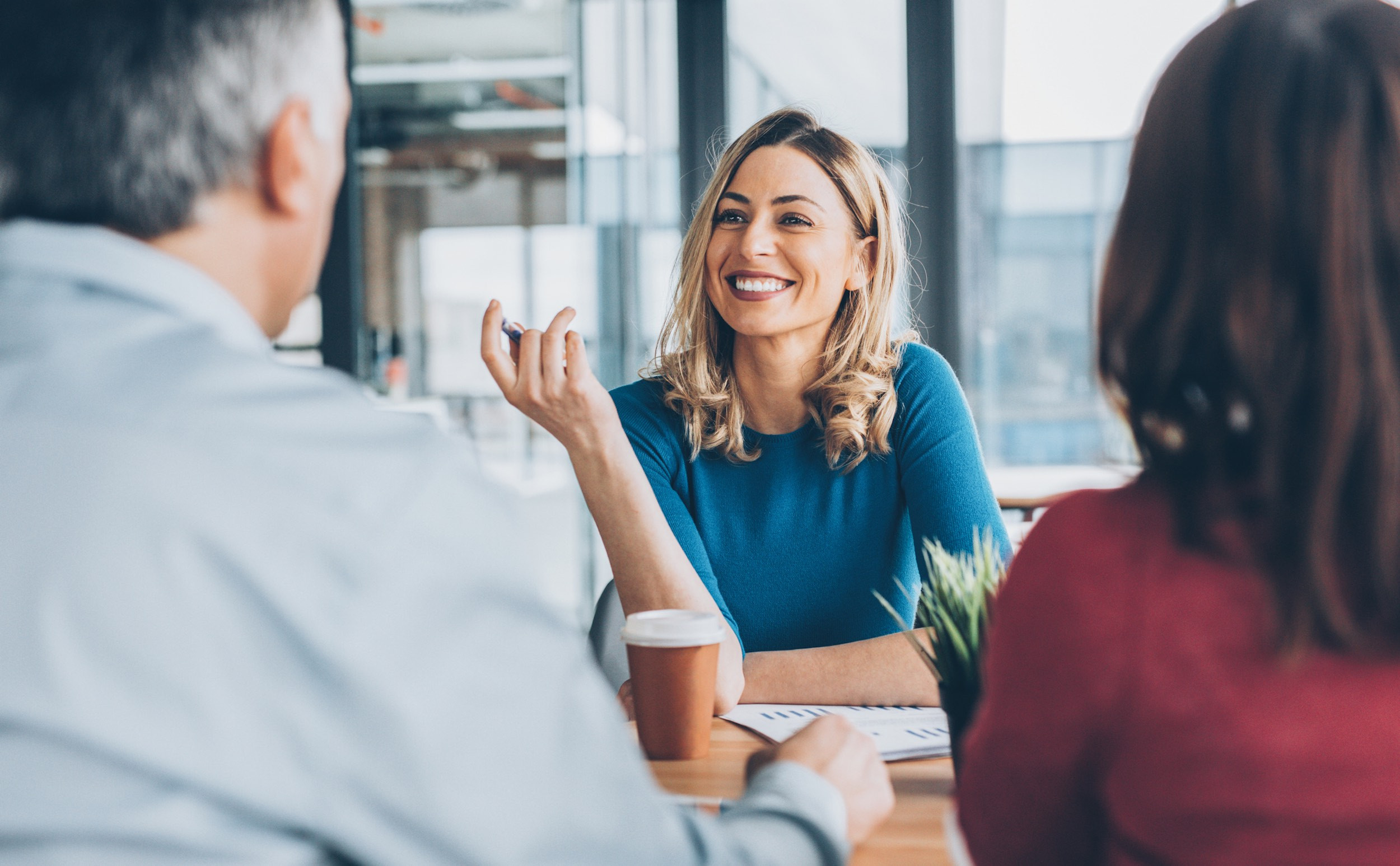 a smiling accountant meeting with couple