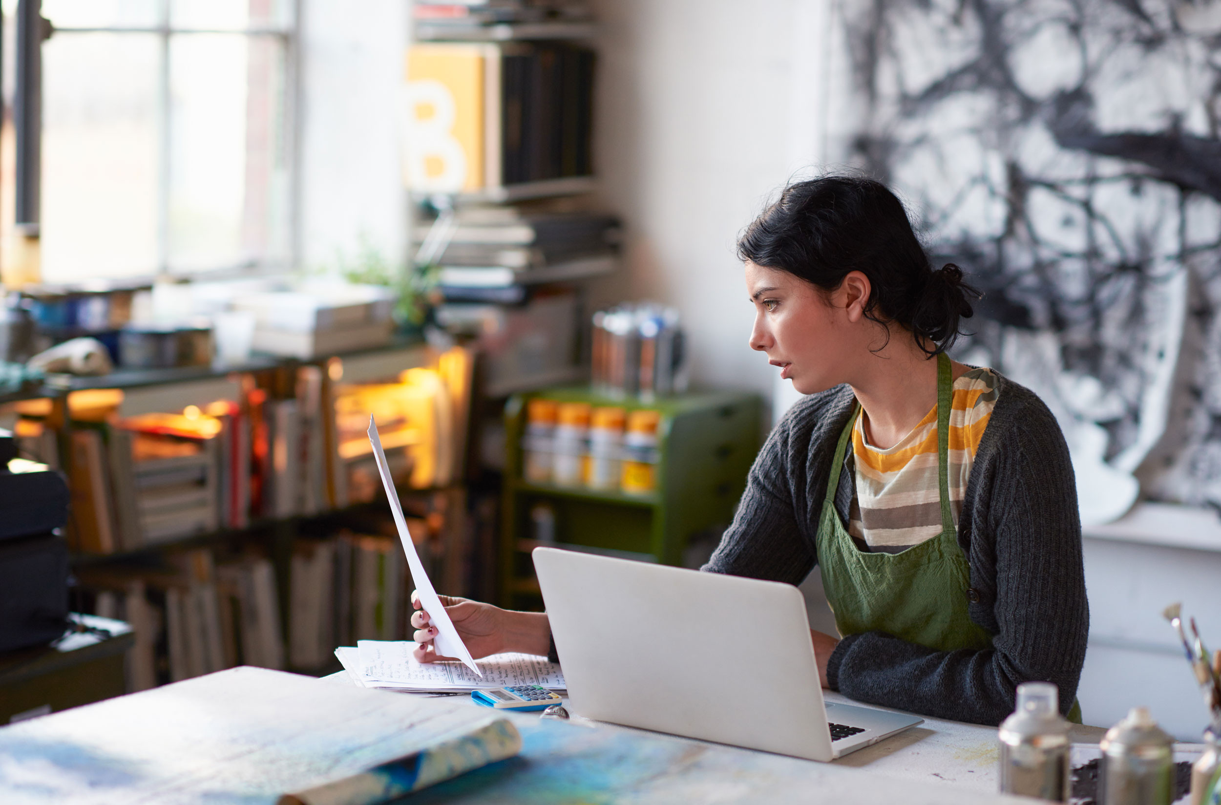 person doing accounting task with computer and documents