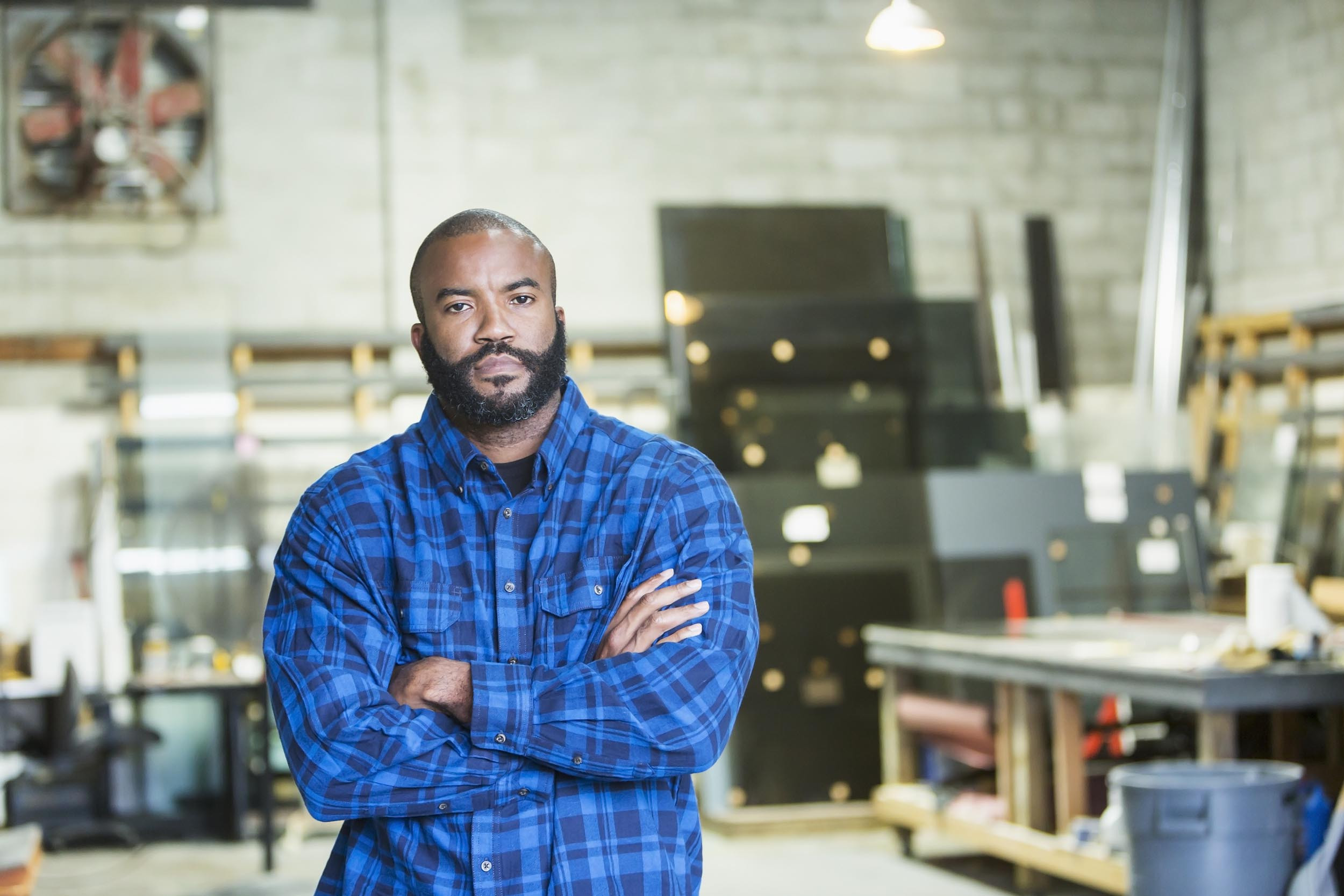 gig worker with hands crossed at office