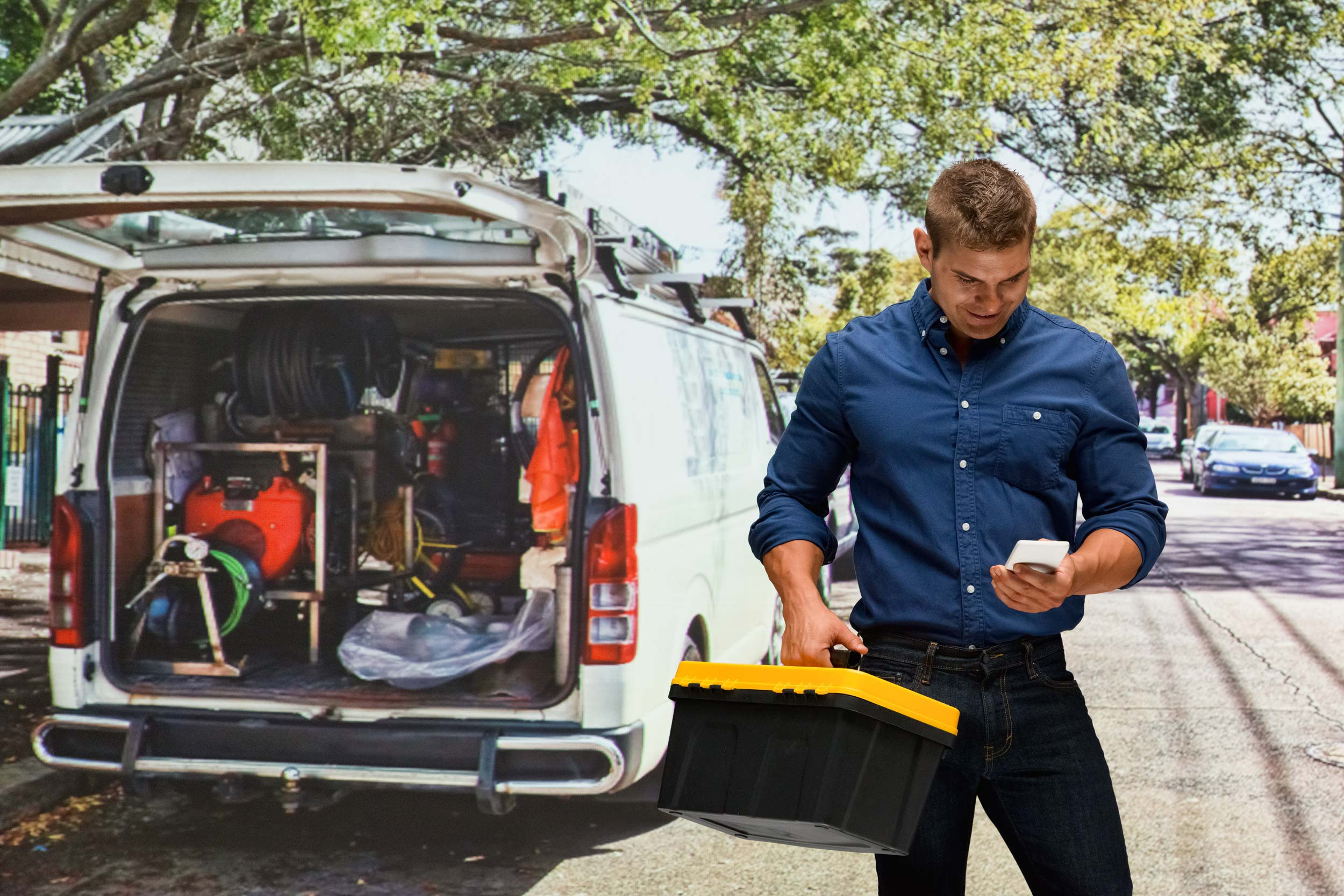 person using phone with contractor van