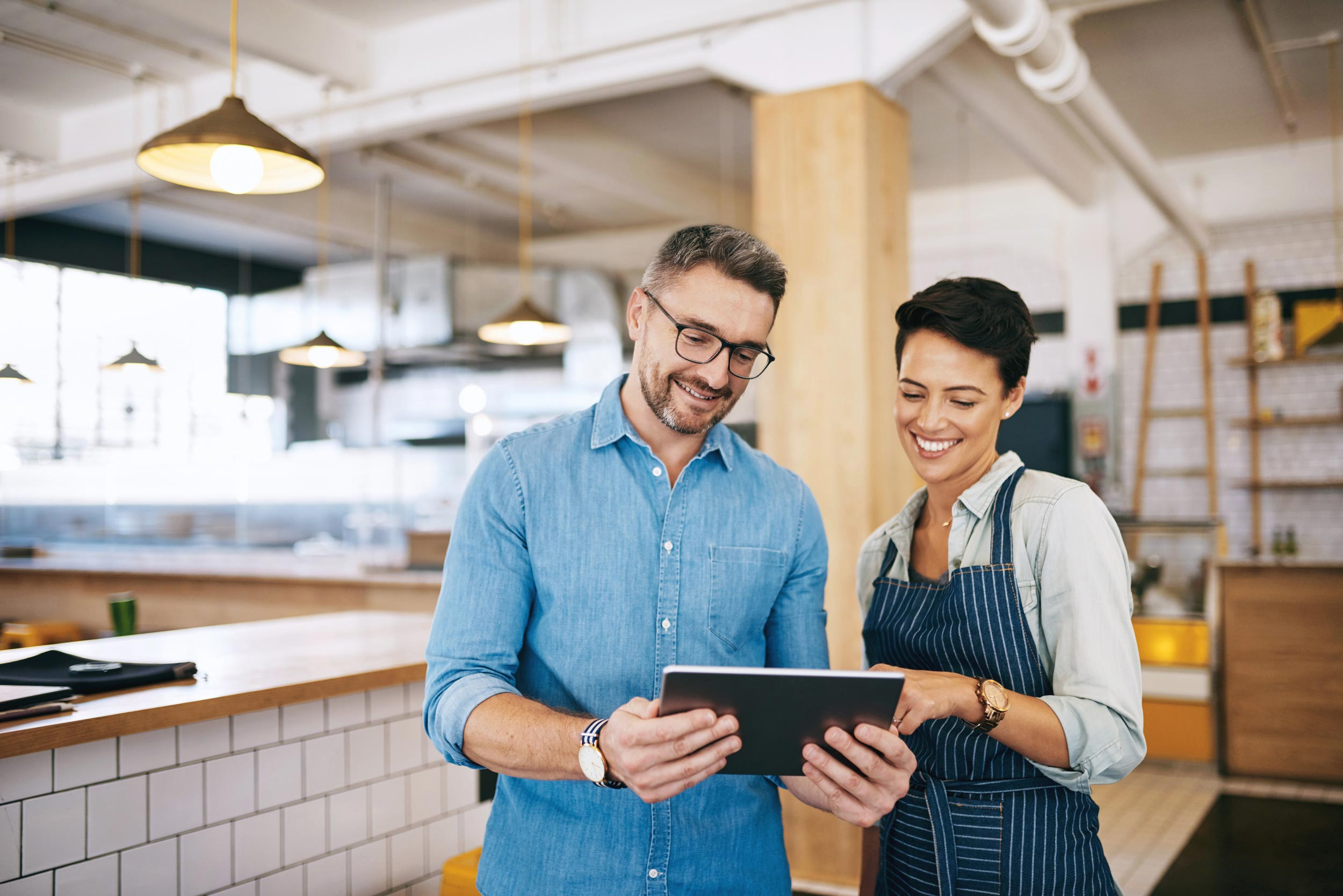small business people using tablet at restaurant