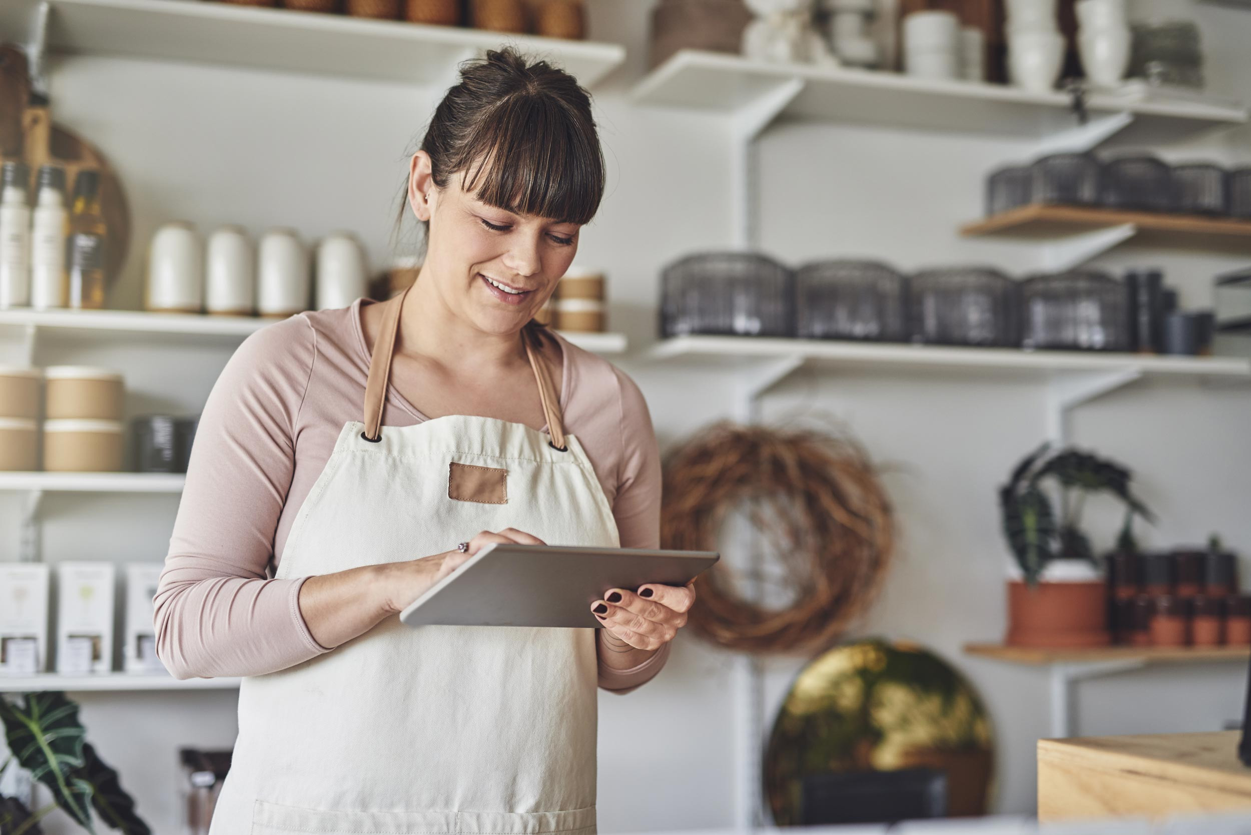 small business owner using tablet at store