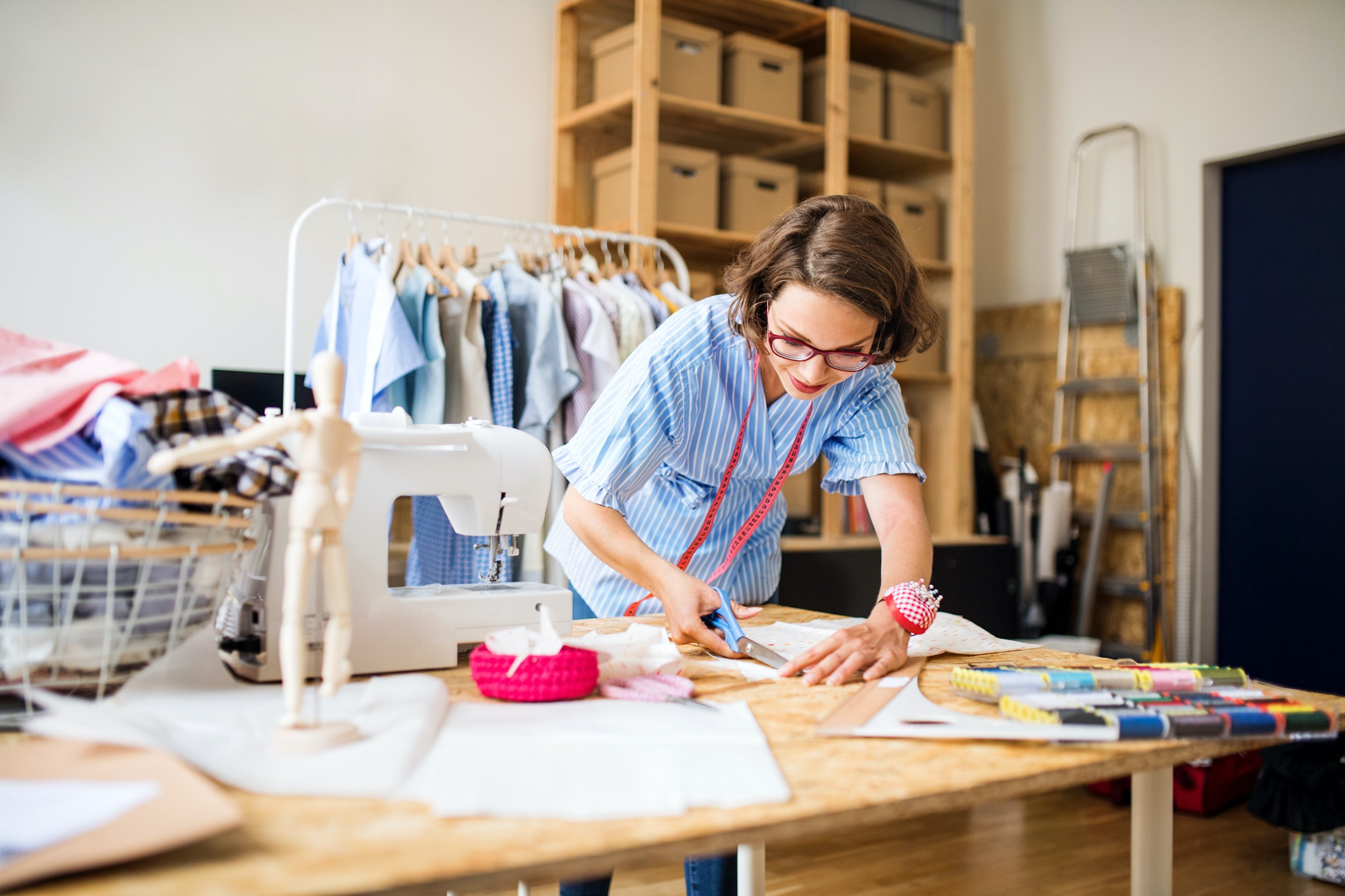 business owner making clothes at store