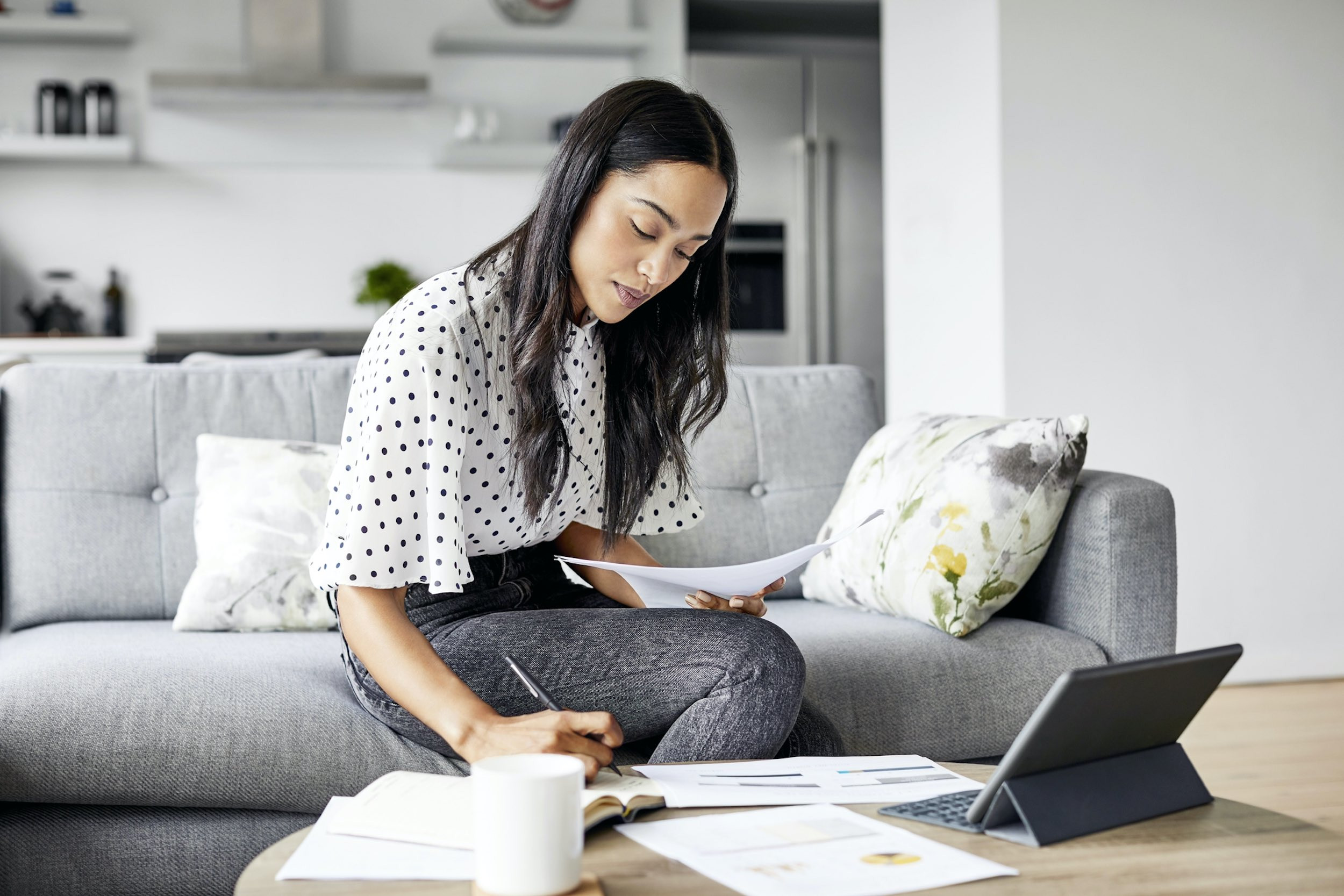 person analyzing documents at home with computer
