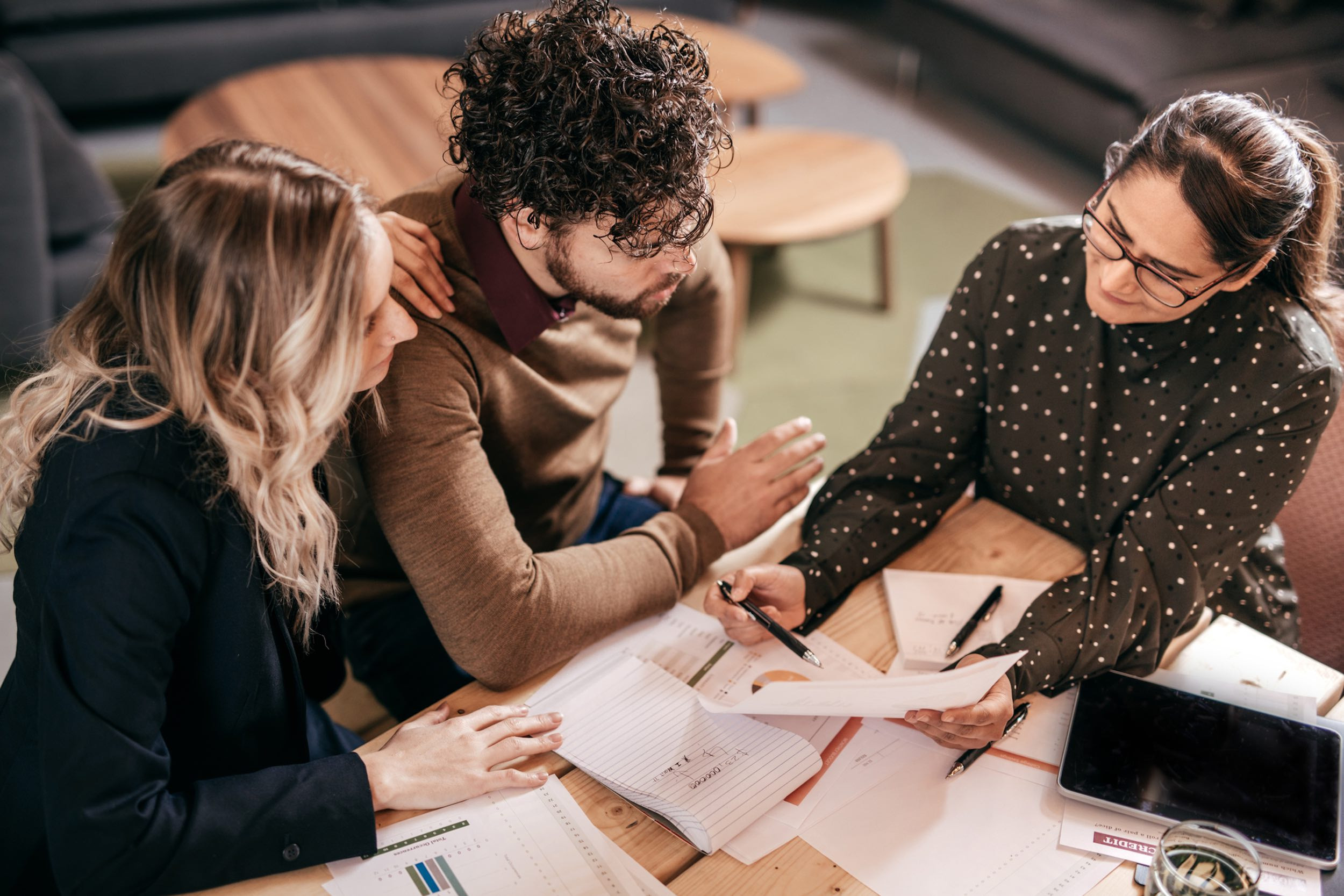 tax meeting with three people looking at documents