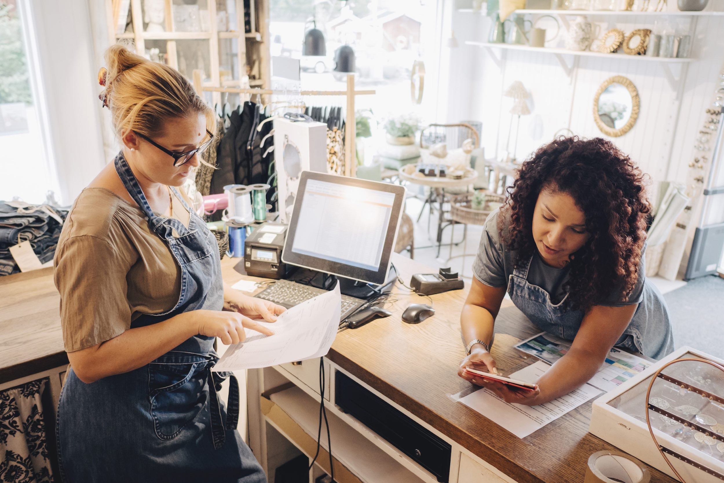 small business shop owners discussing receipt at shop