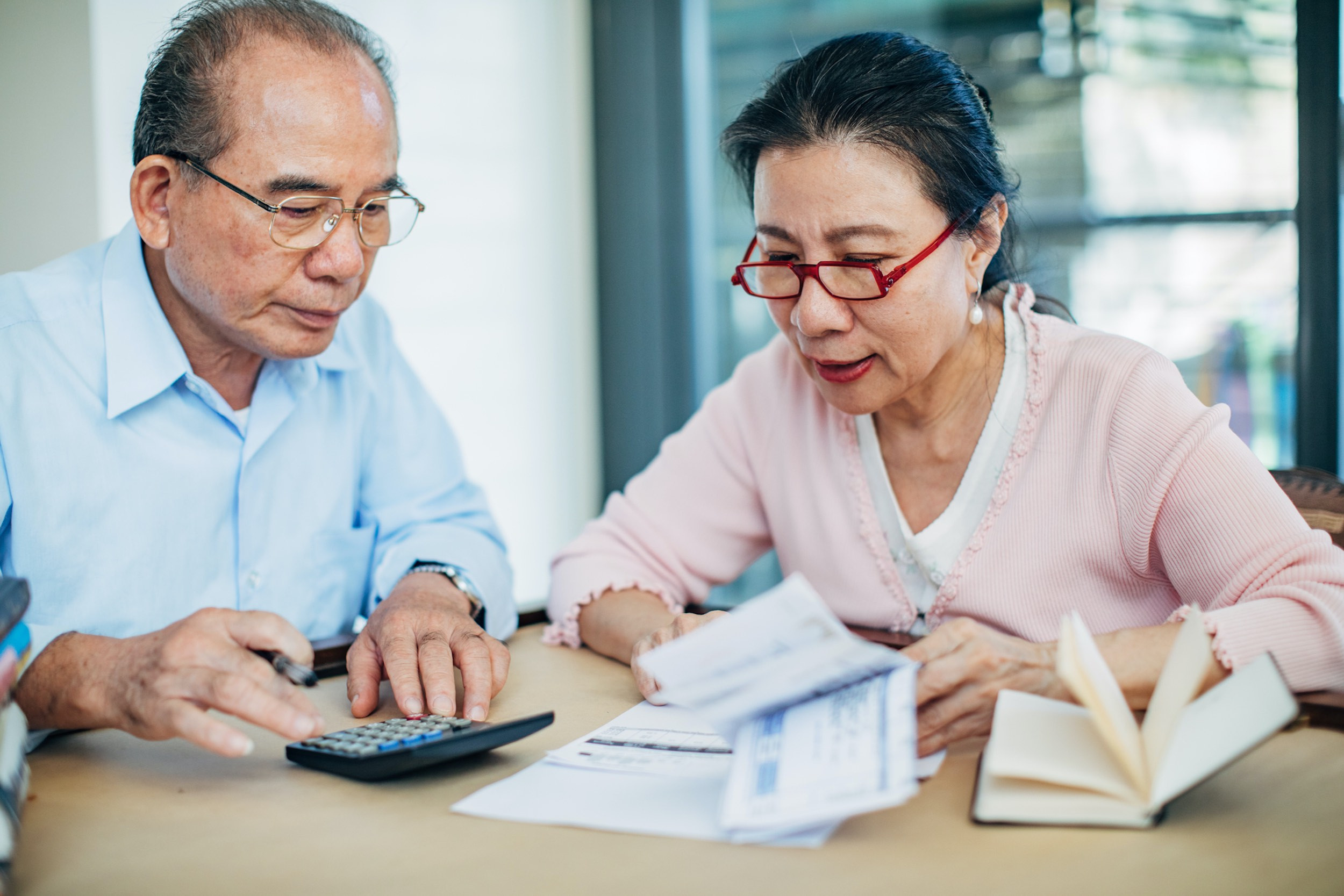 senior couple doing finances with using calculator