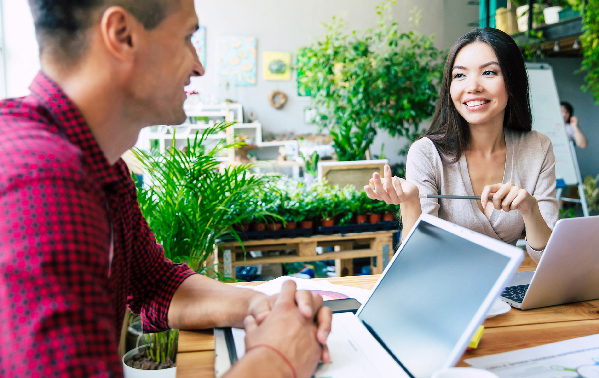 accounting discussion between two person in green background