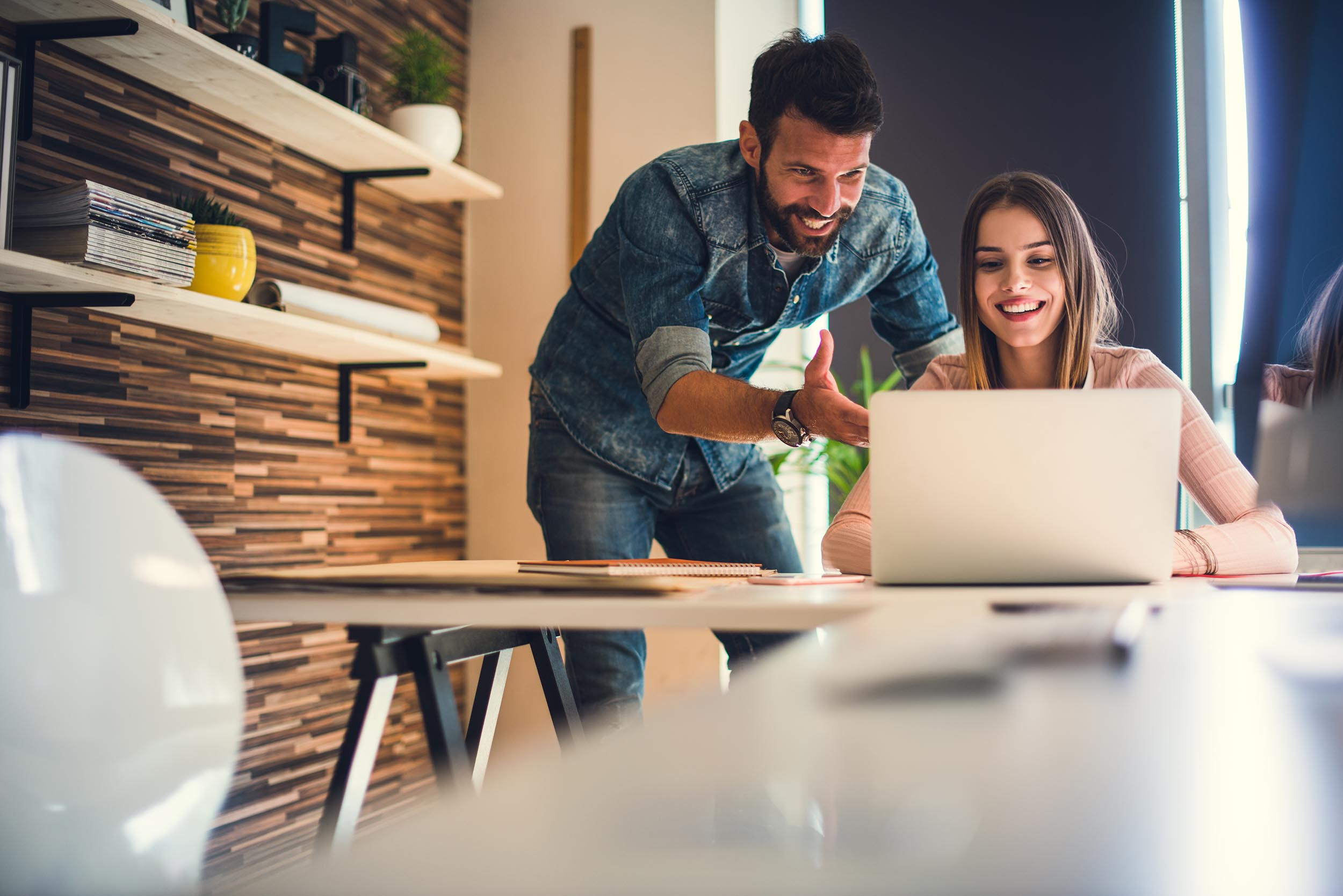 two persons happy at work with the laptop