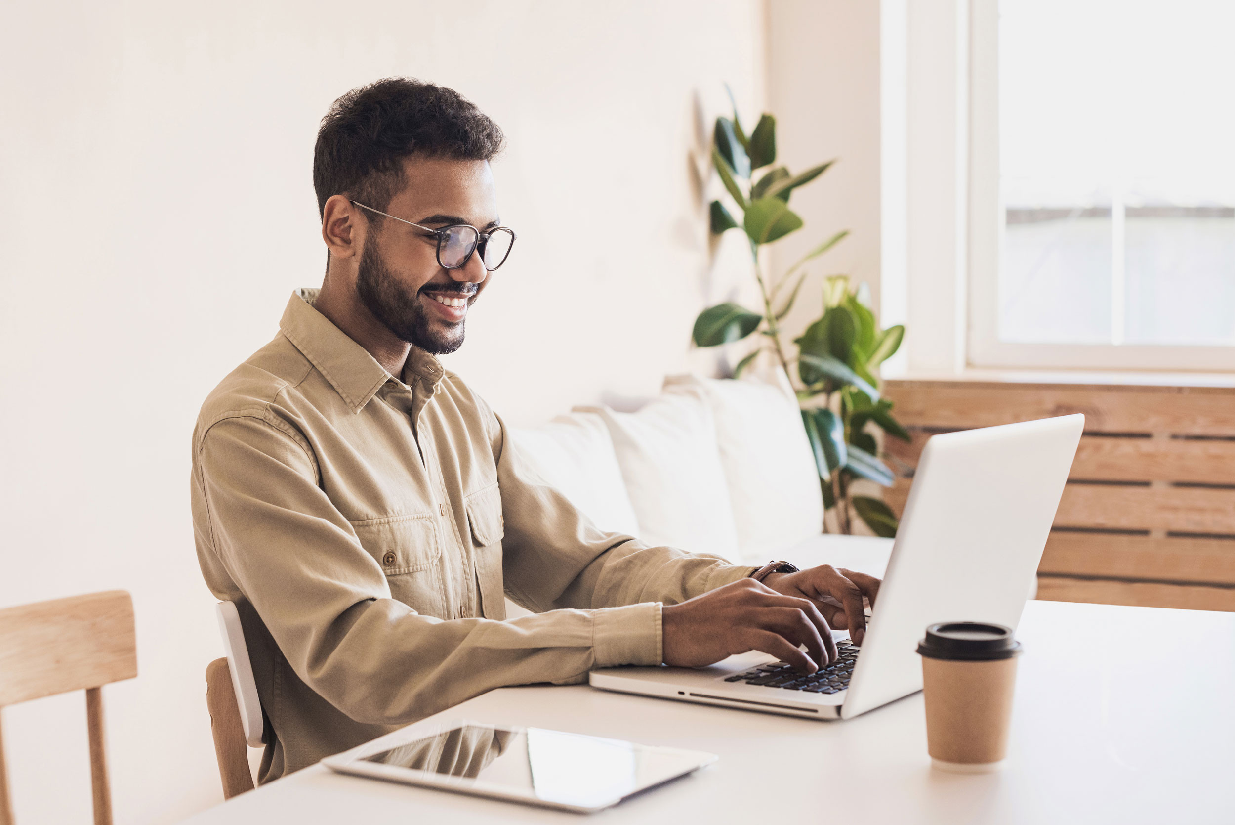 a person happily working with the laptop
