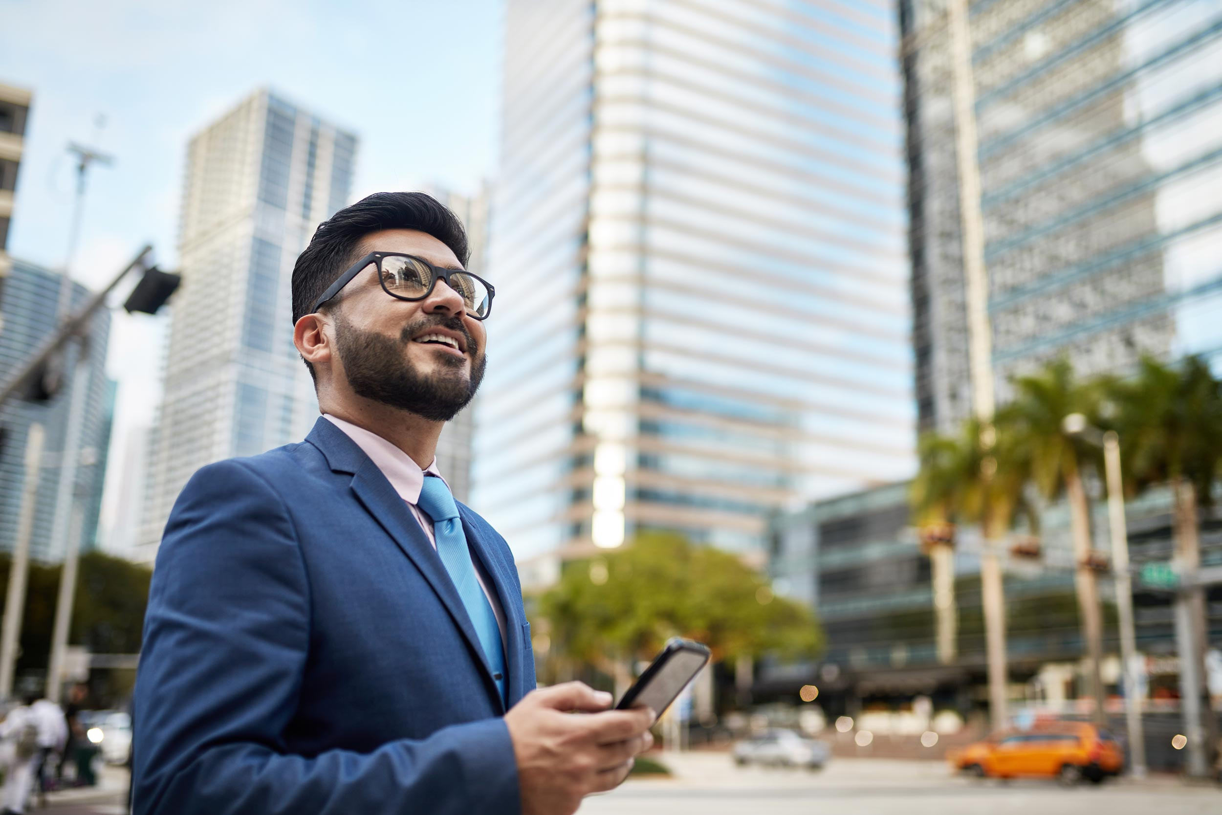 a person standing in miami street with phone in hand